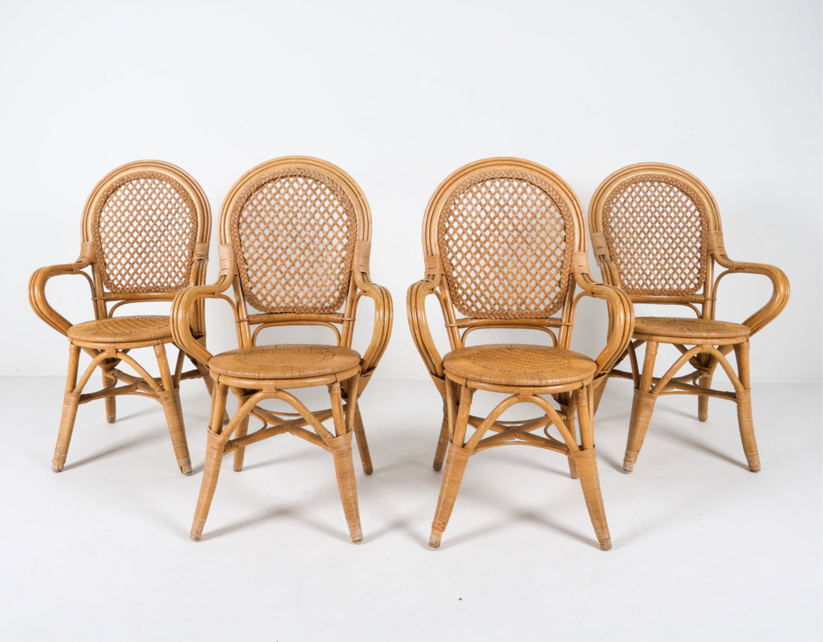 (4) SCANDINAVIAN BAMBOO AND RATTAN ARMCHAIRS: Late 20th century Dimensions: H 40.25" x W 24" x D 17" x SH 18.25". Condition: Scattered scuffs and dings, some surface soiling. Wear consistent with age and use. PER A036