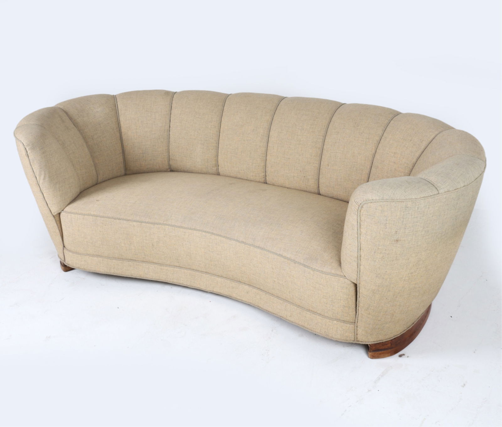 DANISH CHANNEL BACK BANANA SOFA: On mahogany legs. Channel back. Circa 1950's. Dimensions: H 27.5" x W 78" x D 31" x SH 14". Conditions: Wear consistent with age and use, A few faint spots of discoloration to seat cushion, PER A56