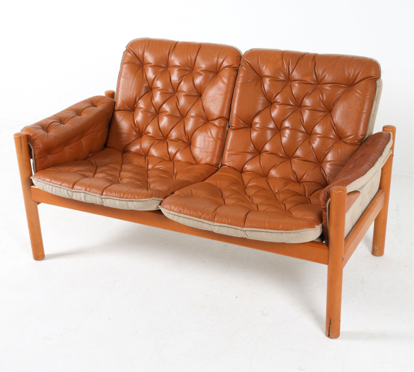 'IREVIK' LEATHER SOFA BY KJELL NORDIN FOR IKEA: Sweden, circa 1980's. Dimensions: H 30.5" x W 52.5" x D 31" x SH 16". Conditions: Light surface wear consistent with age and use, a few faint rubs. Few darker scuffs on legs. PER A70