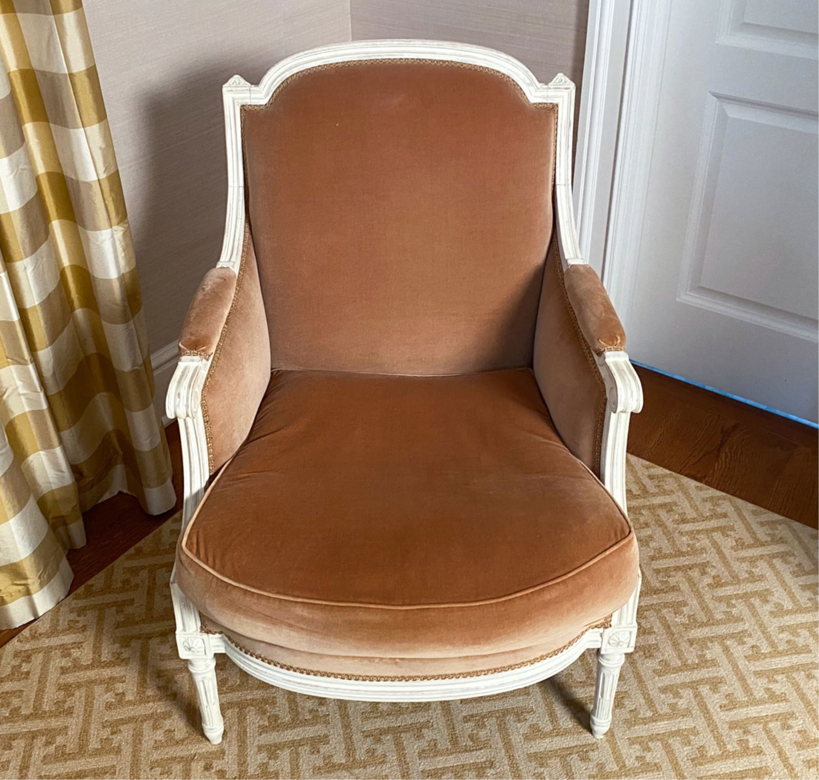 FRENCH LOUIS XVI STYLE BERGERE CHAIR: With down filled cushion and velvet upholstery Dimensions: H 39" x W 26" x D 26" S.H. 18" Condition: Minor wear consistent with age and use, intentionally distressed finish to frame.