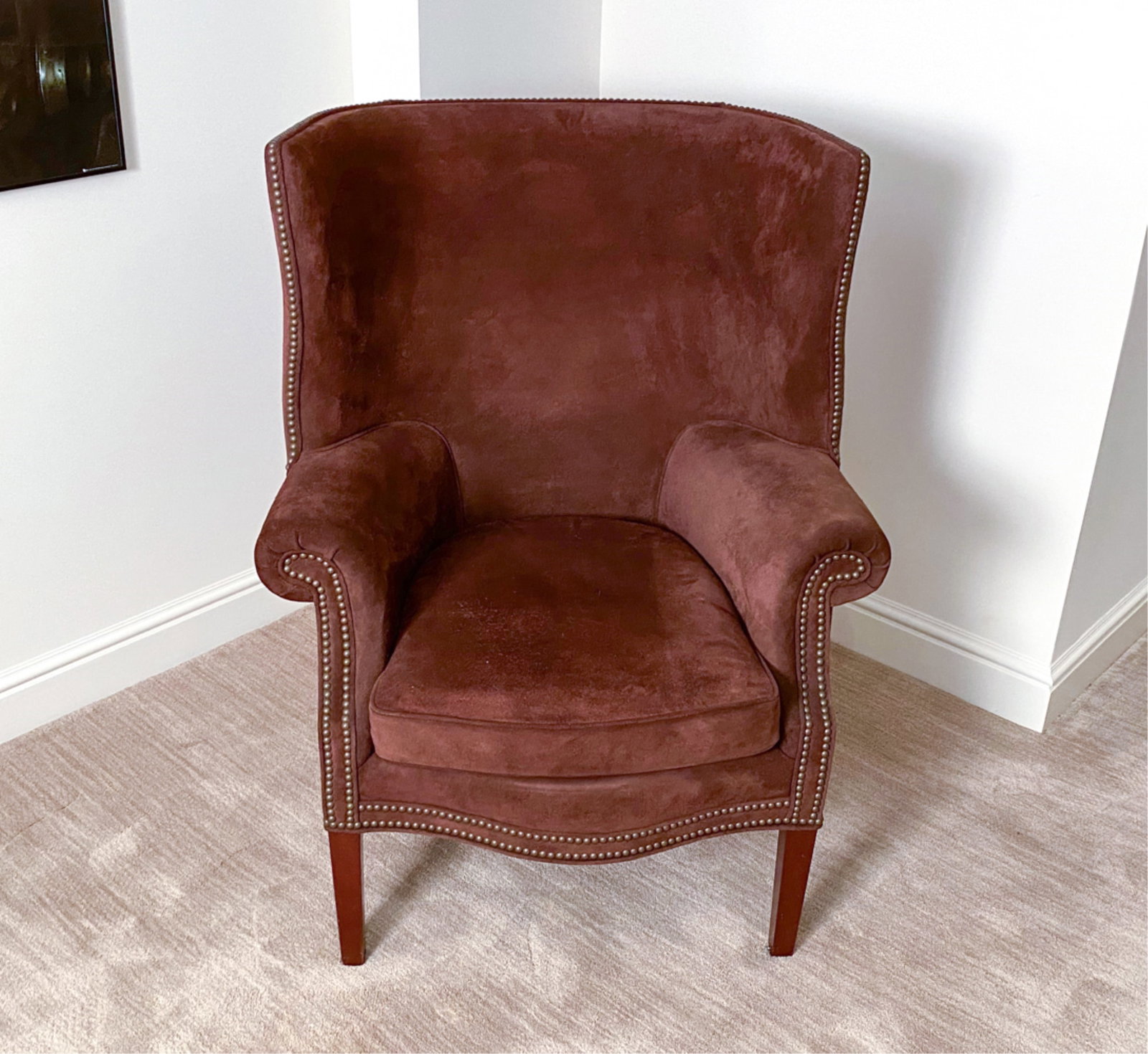 SUEDE WINGBACK LOUNGE CHAIR: With nail head accents. Dimensions: H 44" x W 34" x D 34" Seat height 19" Condition: No issues to note