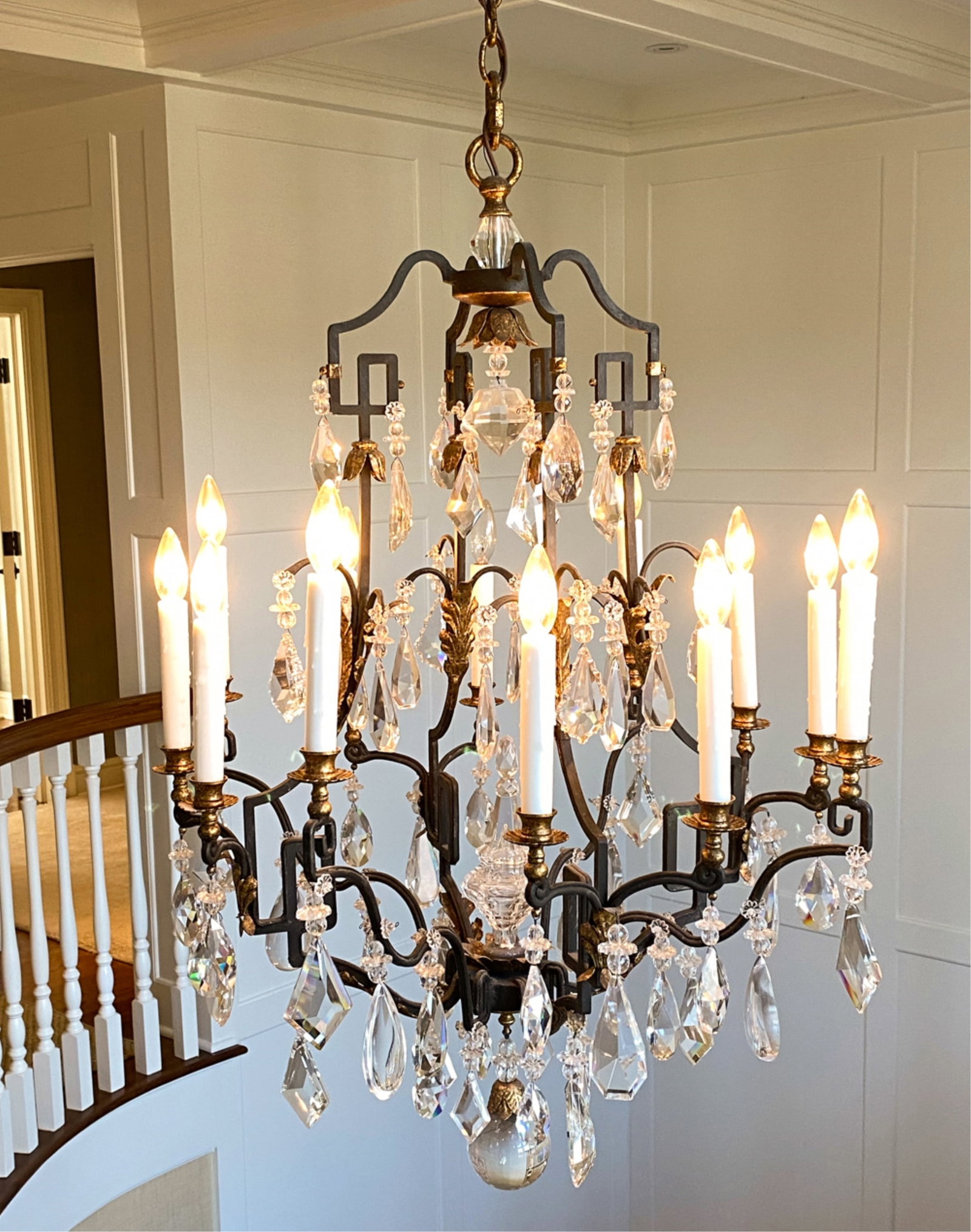 DENNIS AND LEEN CRYSTAL CHANDELIER: Wrought iron frame. From ceiling canopy to crystal pendant H 47" x Dia 29" Condition: No issues to note