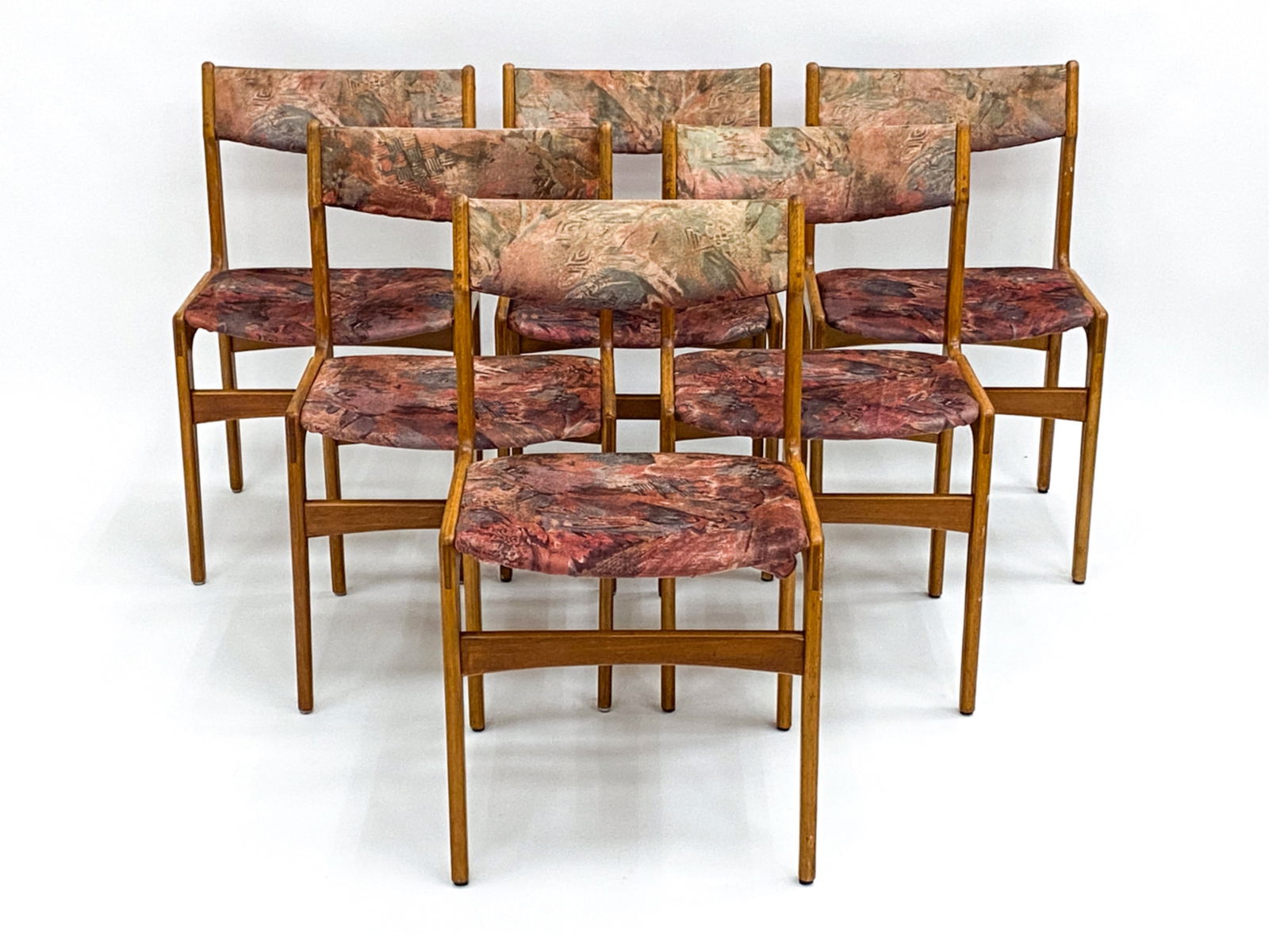 (6) ERIK BUCH DANISH TEAK DINING CHAIRS: Six teak side chairs designed by Erik Buch. Manufactured by Oddense Maskinsnedkeri. Dimensions: H 31" x W 19" x D 16.75" x SH 18" Condition: Slight sun fading to back upholstery, along with minor hole