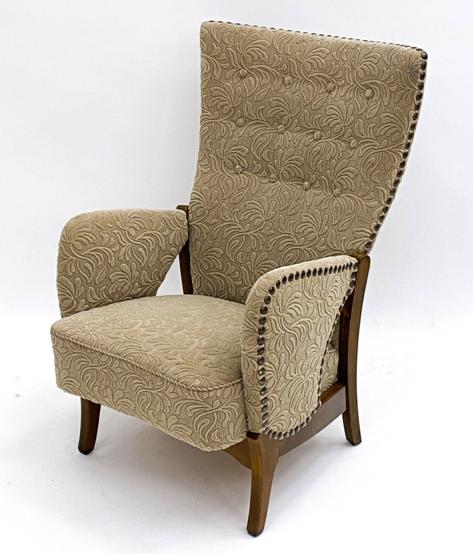 SWEDISH HIGHBACK LOUNGE CHAIR C.1950'S: Highback with raised floral designs. Studs to edges of backing and arms. Cord accent to seat. Dimensions:H 38"x W 24" x D 23" Seat height 16" Condition: Marks and scratches to beech legs. Wear consist