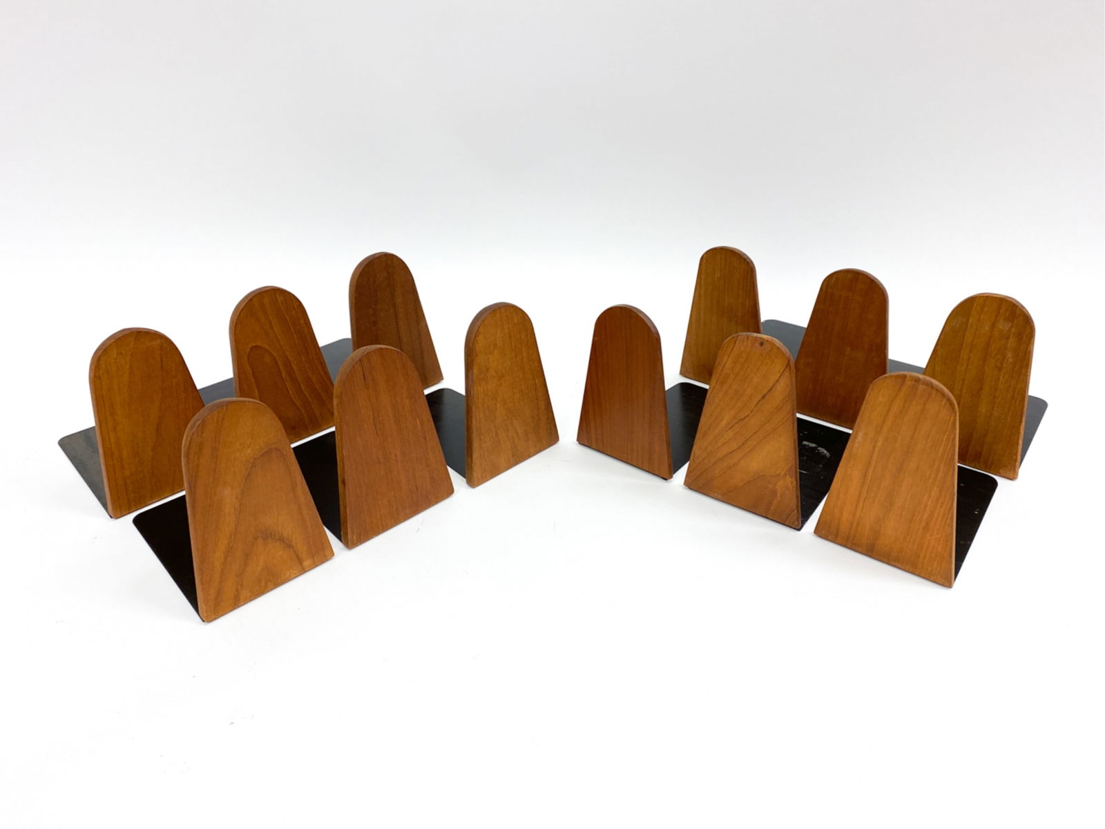 (12) KAI KRISTIANSEN DANISH TEAK BOOKENDS C. 1960S: Teak & steel bookends. Dimensions:(Largest) H 5.5" x W 4" x D 6" Condition: Wear consistent with age and use. Marks and scratches to wood and metal plate.
