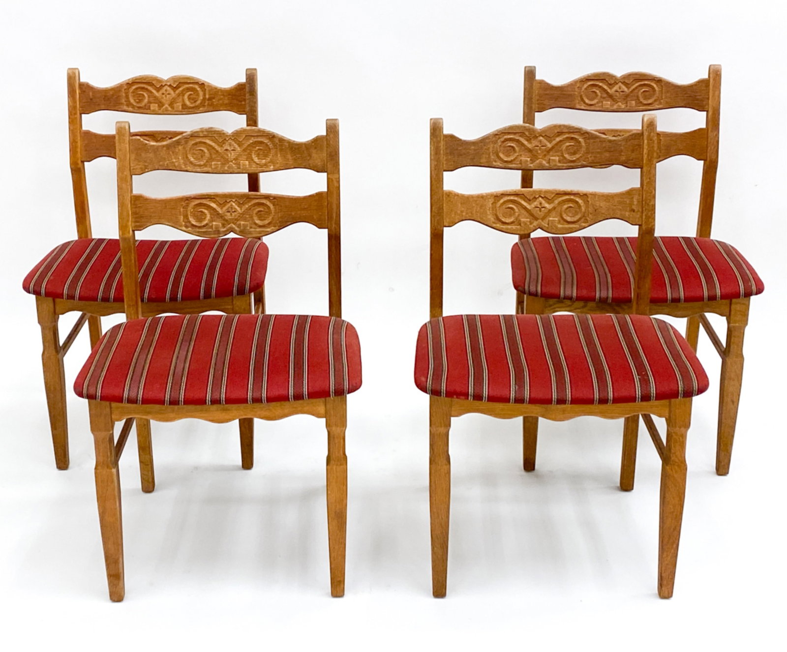 (4) HENNING KJAERNULF DANISH OAK DINING CHAIRS: four Mid-Century oak dining chairs designed by Henning Kjaernulf. Labels under. Dimensions: H 31.75" x W 20" x D 18" x SH 17.34" Condition: Minor surface wear, scuffs and scratches consistent with age