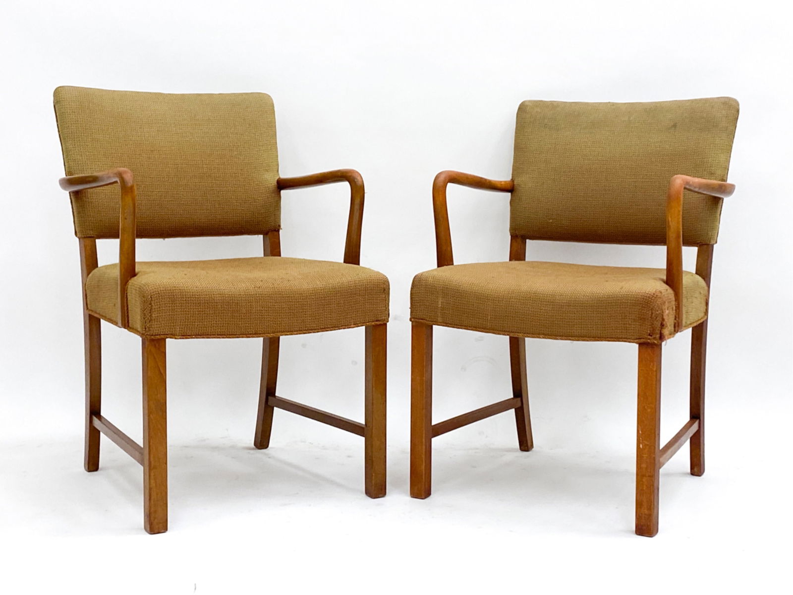 PAIR DANISH OAK CHAIRS IN THE STYLE OF KAARE KLINT: In the manner of Kaare Klint C.1940's Dimensions: H 32.5" x W 23" x D 19" Seat height 18" Condition: Wear consistent with age and use. Candidate for reupholstery. Discoloration and marks to arms and l