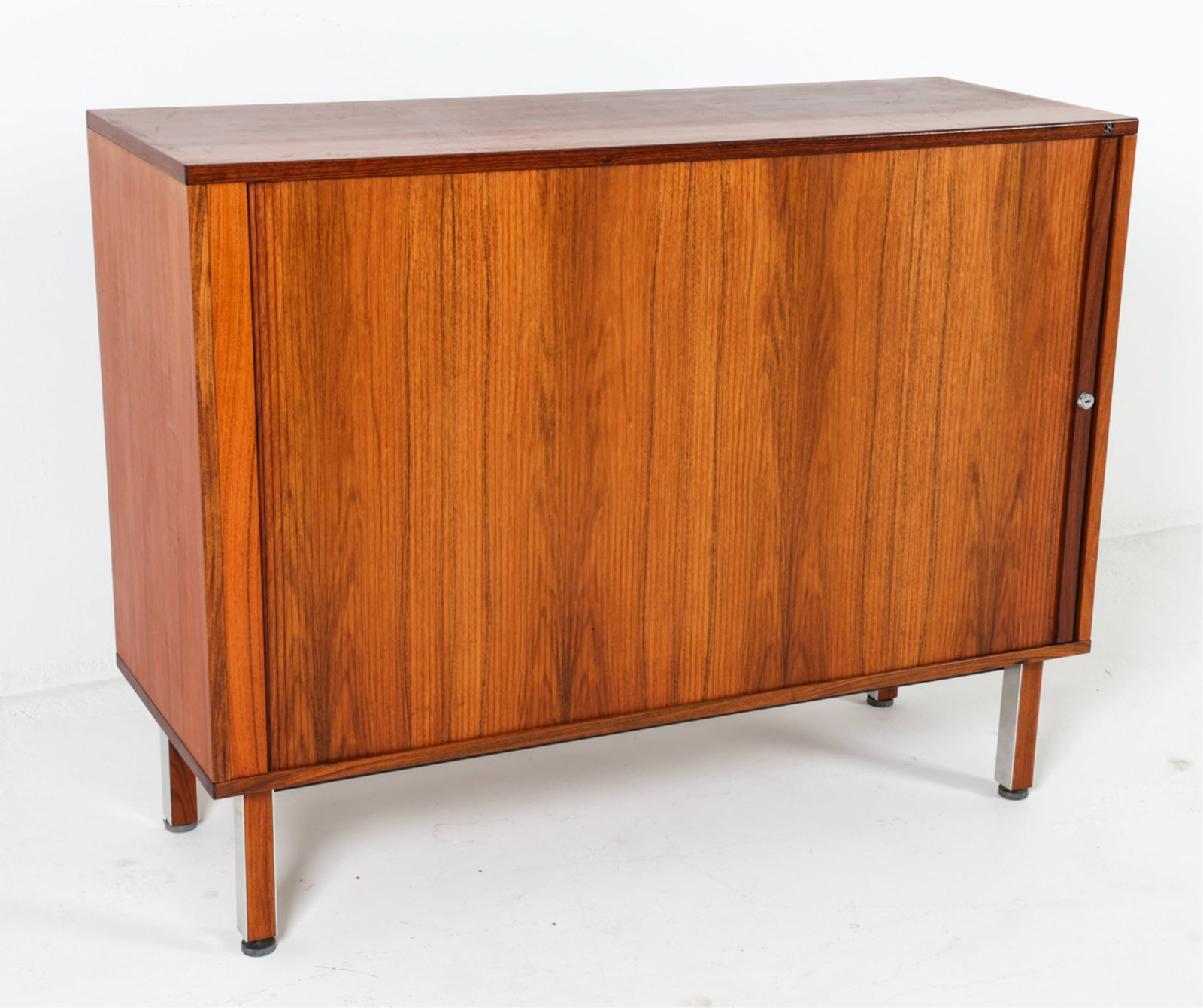 NIPU DANISH ROSEWOOD SIDEBOARD W/ TAMBOUR DOOR: Adjustable shelves within. Chrome accents on legs. Dimensions: H 37" x W 47.5" x D 18" Condition: Scattered marks and scratches to top. Wear consistent with age and use. DMJ 87B