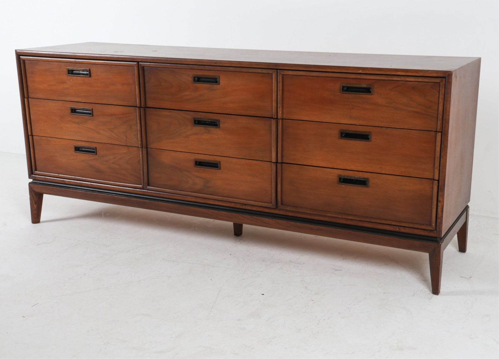 STANLEY FURNITURE WALNUT CHEST OF DRAWERS: Rectangular recessed drawer pulls. Mid to late 20th century. Dimensions: H 30" x W 71.5" x D 19". Condition: Slight tobacco odor. Few scuffs, dings. Faint surface scratches. Wear consistent with age a