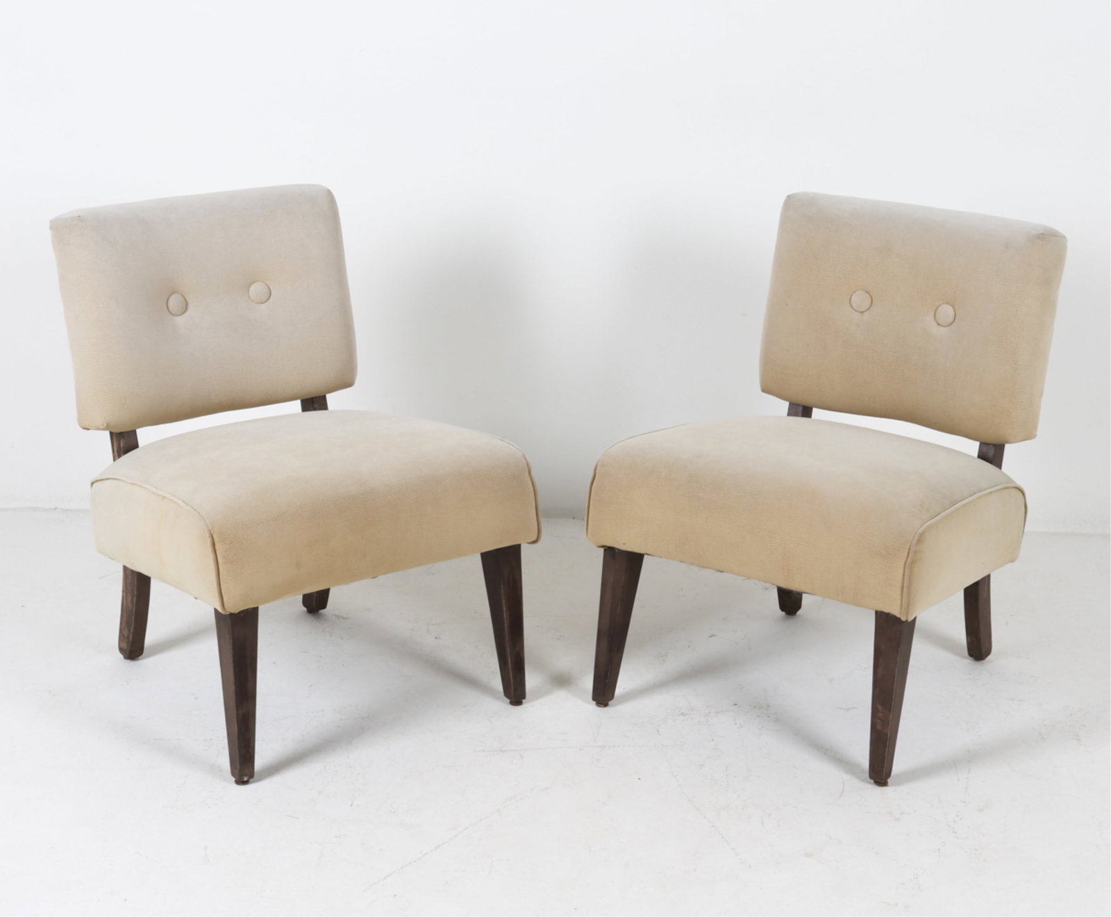 PAIR OF VINTAGE SLIPPER CHAIRS: late 20th century. Dimensions: H 32" x W 21.75" x D 23" x SH 18.5". Condition: Few tears to vinyl, some discoloration and surface soiling. Scuffs and minor losses to finish on legs. Wear consistent wi