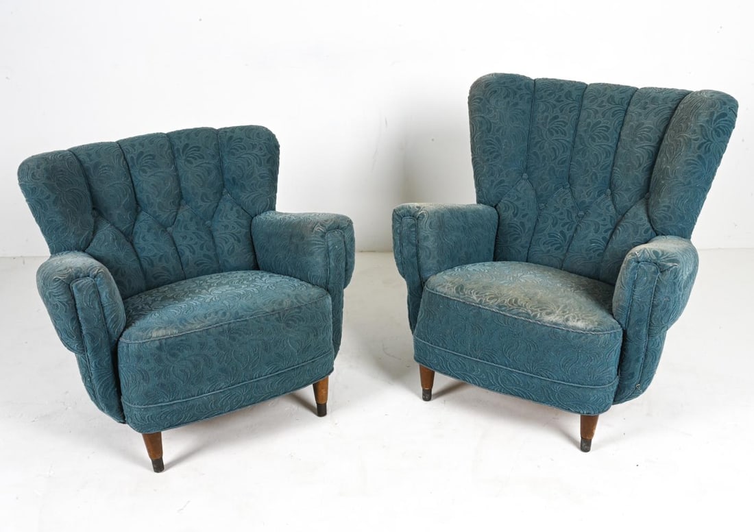 (2) EASY CHAIRS IN THE STYLE OF FLEMMING LASSEN: Whispering tales from an era gone by, this pair of Danish mid-century lounge chairs beckon you to a world where elegance was etched in every fiber and artistry arose from every curve. Drawing inspirat