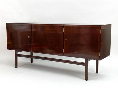 OLE WANSCHER MAHOGANY SIDEBOARD: An iconic piece of Danish design history, the Rungstedlund sideboard by Ole Wanscher is timeless in its exquisite luxury and minimalist silhouette. Produced by Poul Jeppesens Furniture in St Heddinge,
