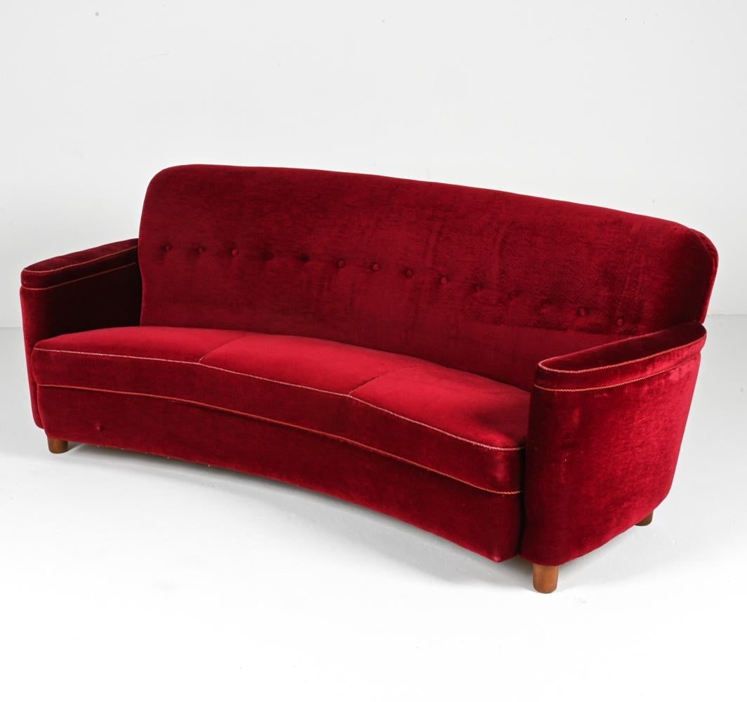 MANNER OF FLEMMING LASSEN DANISH MID-CENTURY SOFA: Journey back to a transformative era of design with this alluring sofa, echoing the style of the legendary Flemming Lassen. A Danish mid-century marvel from the 1940s, this piece captures the imaginat