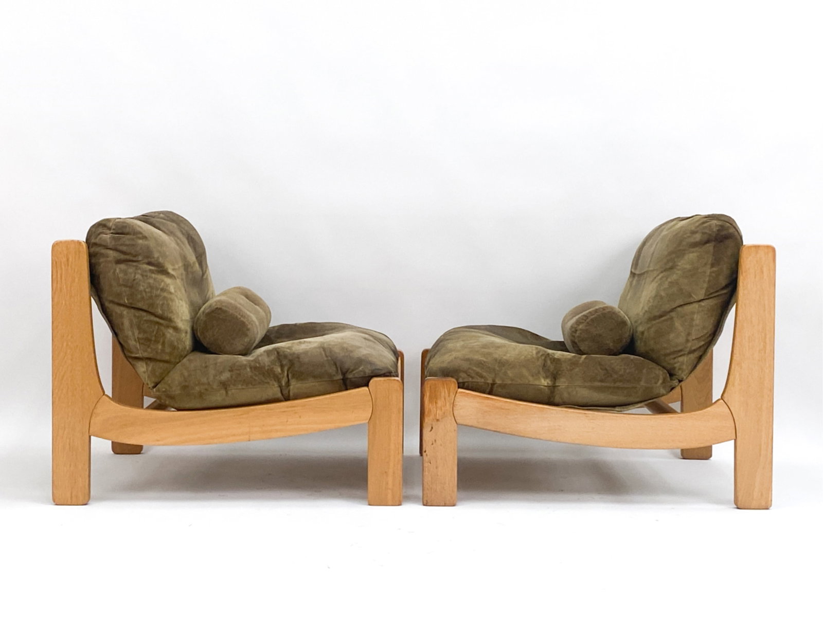 PAIR OF GERMAN BRUTALIST MODULAR LOUNGE CHAIRS: Beechwood and suede chairs with canvas liners. Circa 1960's. Unmarked. Both with lumbar cushions. Dimensions: H 29" x W 29" x D 33" x SH 15.5" Condition: Wear to suede upholstery consistent with age a