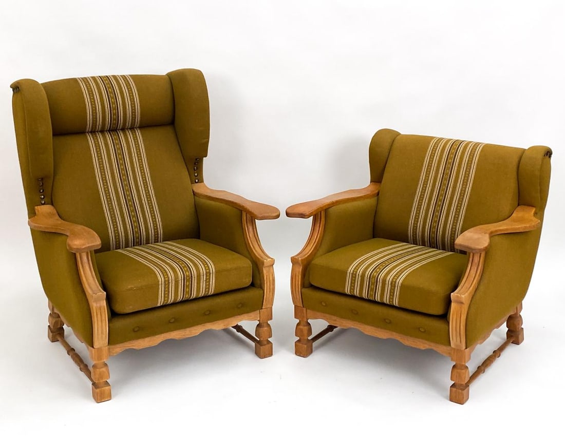 (2) HENNING KJAERNULF CARVED OAK LOUNGE CHAIRS: Step into a world of refined elegance with these impeccable "His & Hers" lounge chairs, masterfully brought to life by the legendary Danish designer, Henning Kjaernulf. Each chair is an ode to the gol