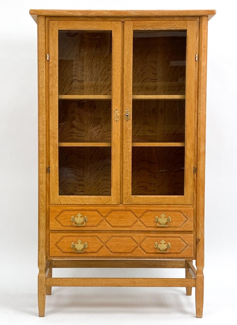 HENNING KJAERNULF MID-CENTURY CARVED OAK CABINET: Bask in the sublime fusion of craftsmanship and elegance with this Henning Kjaernulf Danish Mid-Century Carved Oak Cabinet. A piece that not only speaks of its time but resonates with the timeless cha