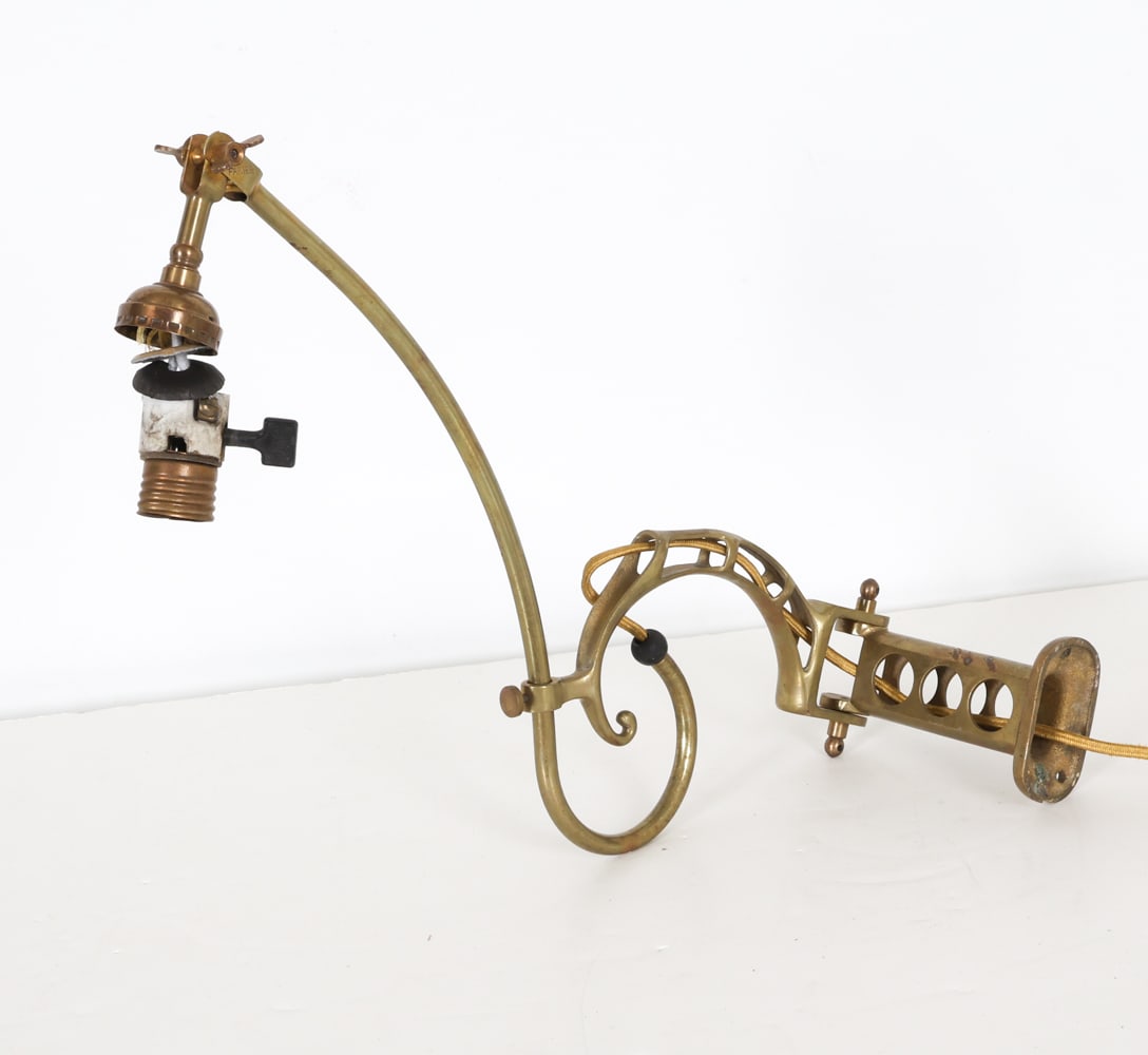 FARIES CO. NO. 20 ARTICULATING BRASS DENTAL LAMP: C. 1910-20s With Articulating arm. Dimensions: H 9.5" x W 20.75". Condition: at one point polished and rewired, currently needing new socket and shade fitter. Scattered scuffs, scratches, some spots o