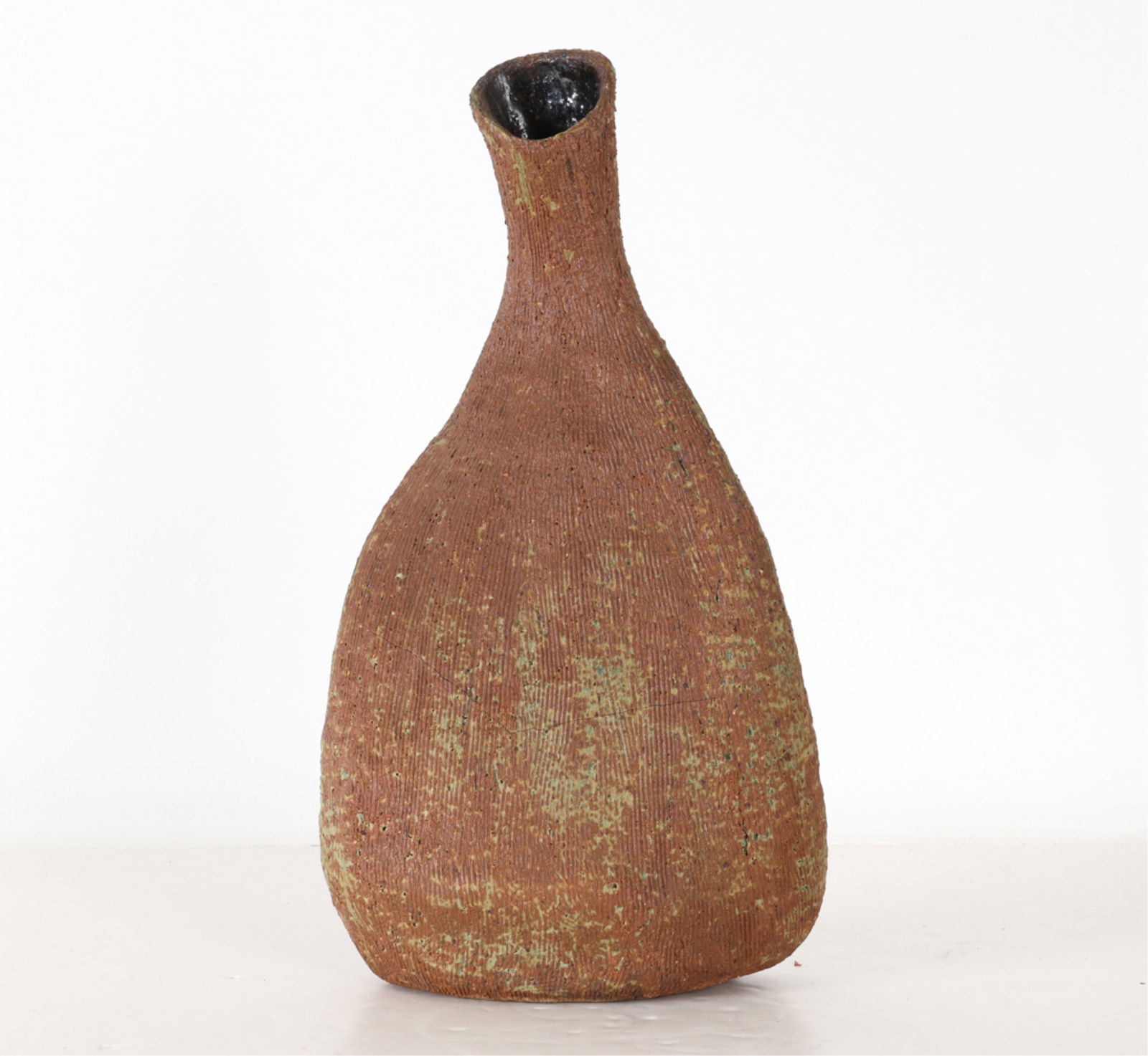 IRENE FRIEDMAN ABSTRACT STUDIO POTTERY VASE: Signed indistinctly under base. Textured scored surface. Mid 20th century. Dimensions: H 17.25" x W 9.5" x D 3.25". Condition: Wear consistent with age and display.