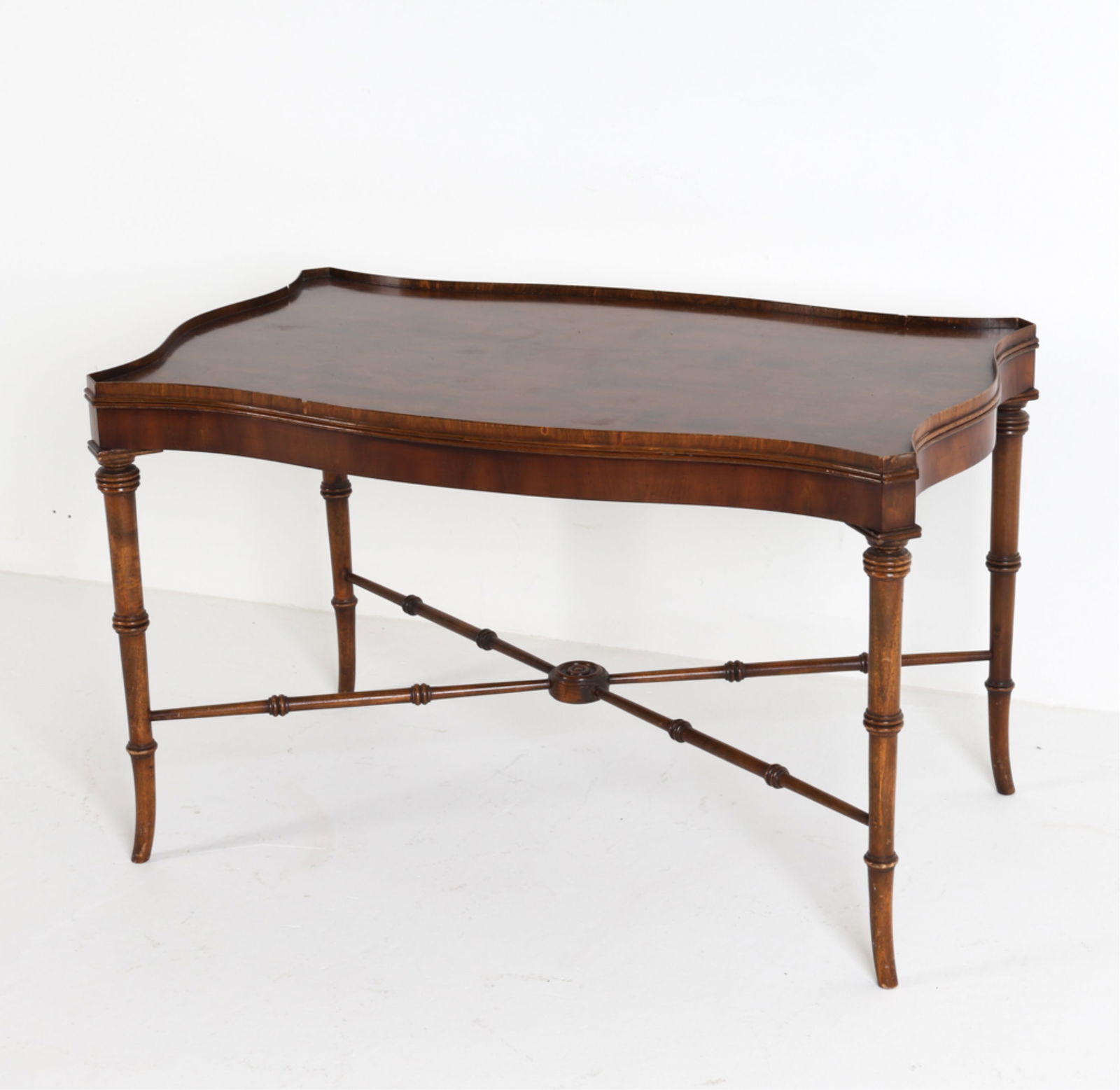 ENGLISH MAHOGANY COFFEE TABLE BY BEVAN FUNNELL: Marked to underside. Brass gate X-form stretcher bar. Dimensions: H 18" x W 29" x D 17.5" Condition: Marks, scratches and losses to brass edges.