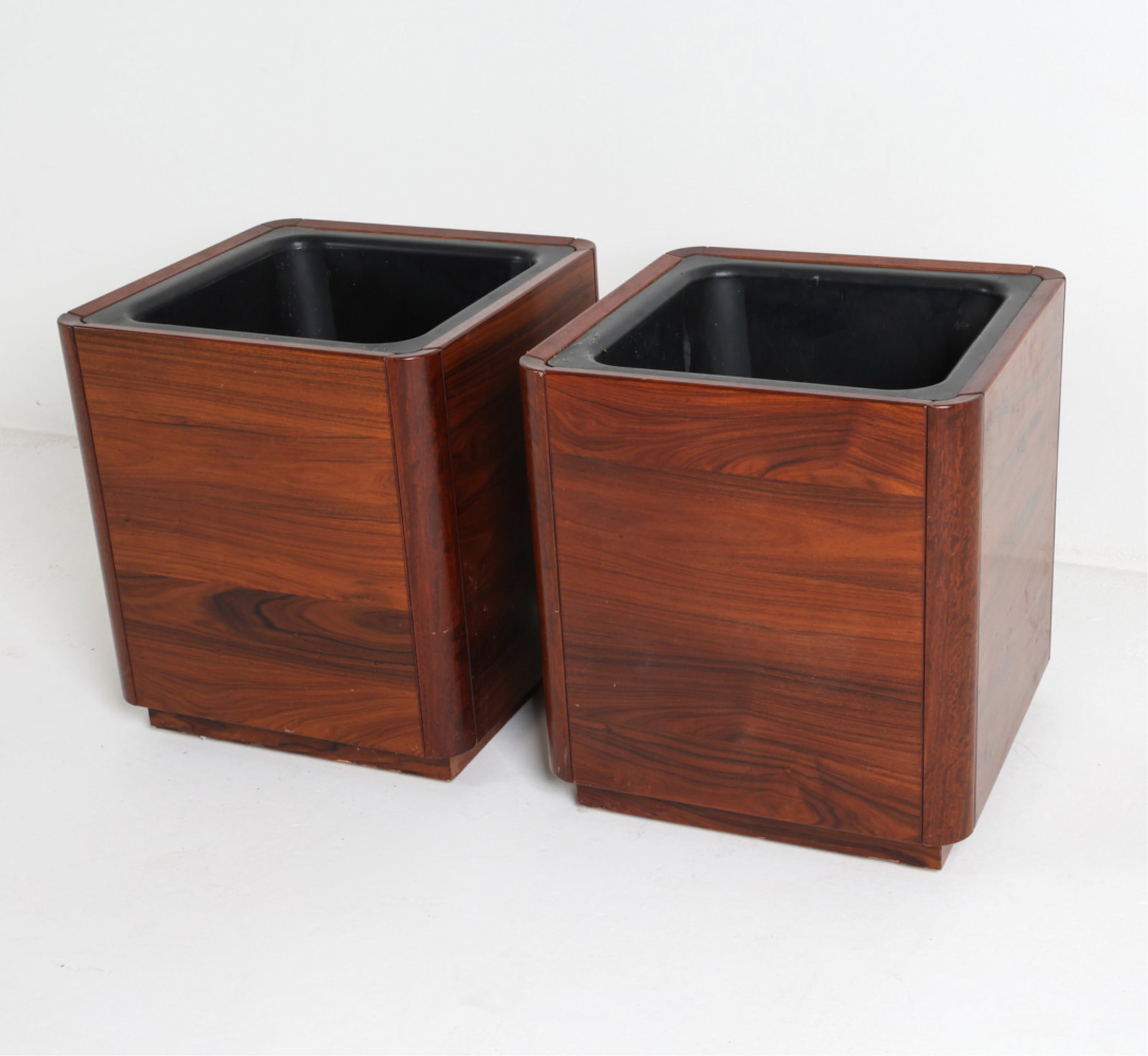 PAIR OF DANISH ROSEWOOD FLOOR PLANTERS, C.1960'S: With removable plastic inserts. Set on casters. Dimensions: H 22" x 19.75" x D 19.75" Condition: Scattered marks, nicks and dings to teak, also to plastic insert. One has small holes drilled into inte