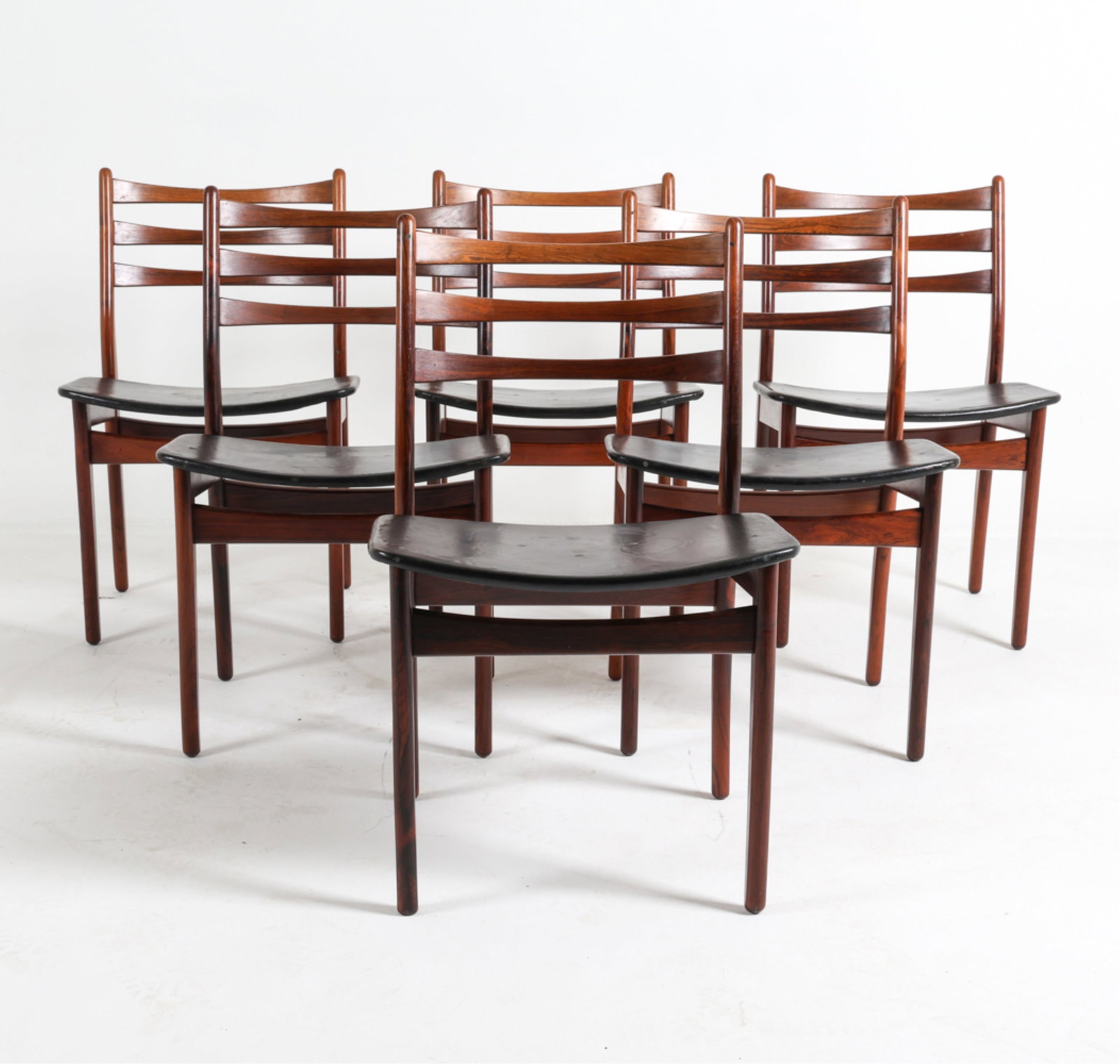 (6) DANISH ROSEWOOD DINING CHAIRS BY TOPFORM: C.1950's Leatherette seats Ladder backs. Unsigned. Dimensions: H 31.5" x W 20" x D 18" Seat height: 18" Condition: Marks and scattered scratches to frames. Creases, marks and discoloration to seats. D