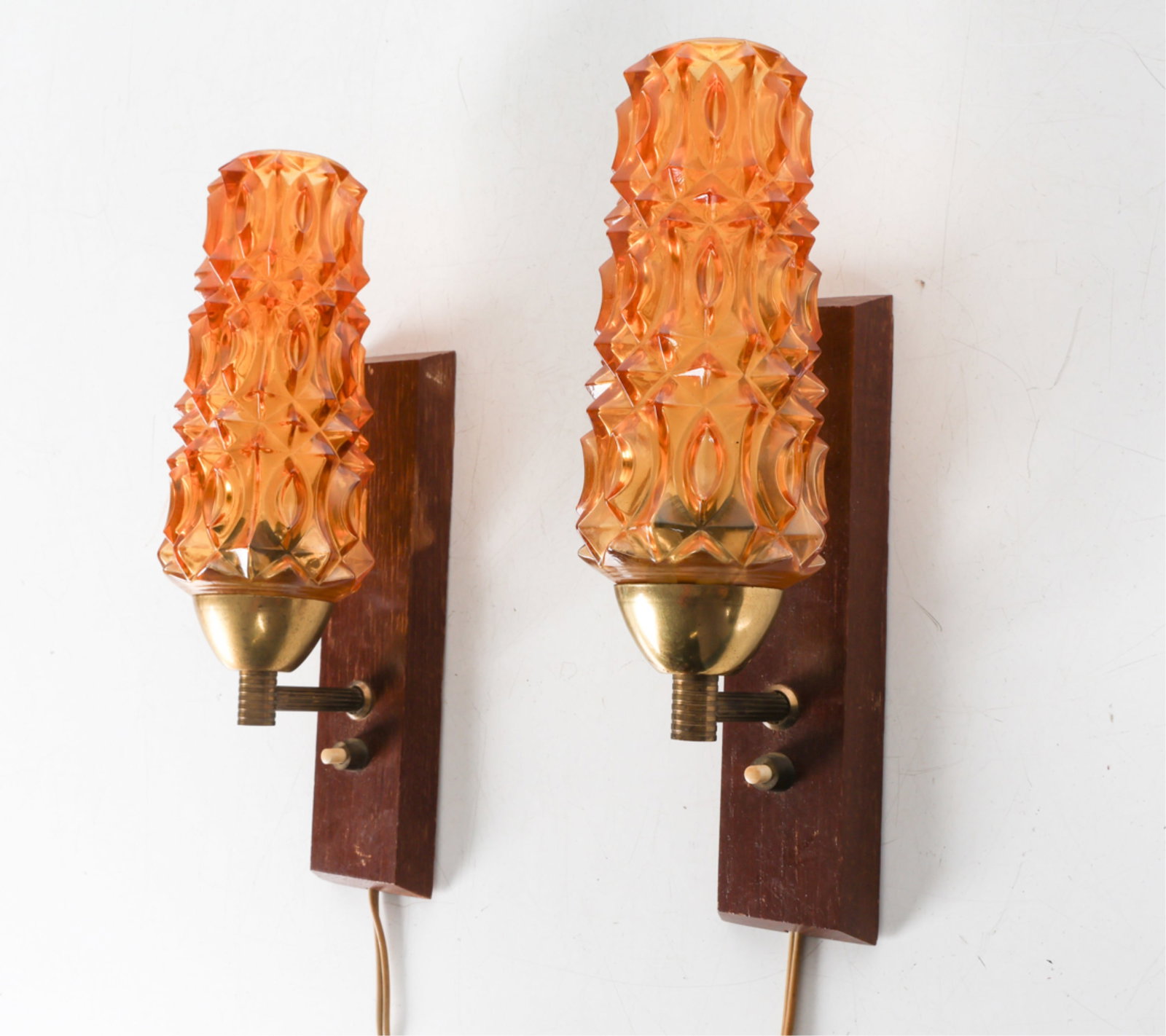 PAIR OF DANISH TEAK & AMBER GLASS WALL SCONCES: Textured amber glass shades with brass fittings. Denmark, circa 1960's. Dimensions: H 11.25" x W 3" x D 4.5". Condition: Wiring untested. Few scuffs, rubs, some surface soiling. Wear consistent with a