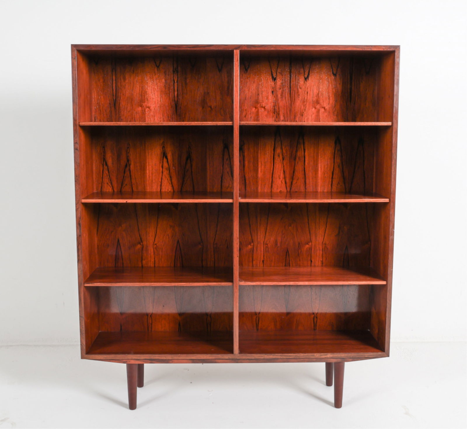 OMANN JUN MODEL 6 DANISH ROSEWOOD BOOKCASE1960'S: With adjustable shelves. Denmark. Dimensions: 55.5 X w 47.5" x D 11.5" Condition: Nicks and losses to backside. Wear consistent with age and use. DMK082