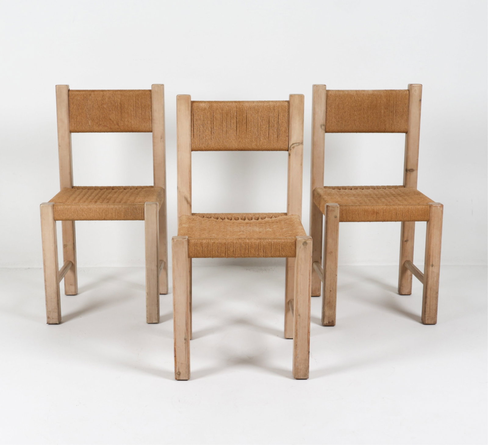 DANISH PINE & PAPERCORD DINING SIDE CHAIRS C.1960S: Lime washed pine. Woven paper cord seats. Denmark. Dimensions: H 35.5" x W 17.5" x D 17.5" x SH 18.5". Condition: Few watermarks to paper cord on seat backs. Scattered scuffs and dings. Wear consisten