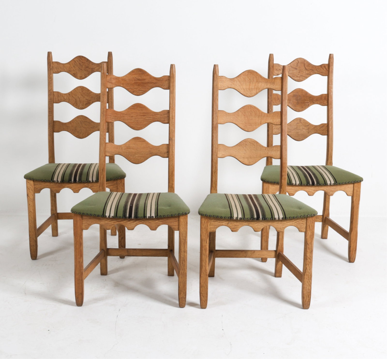 (4) KJAERNULF FOR NYRUP DANISH OAK DINING CHAIRS: Striped wool upholstery. Circa 1970's. Dimensions: H 40.25" x W 20" x D 16.5" x SH 17.5". Condition: Small scuffs and dings. Minor surface soiling to fabric. Wear consistent with age and use. DMK108