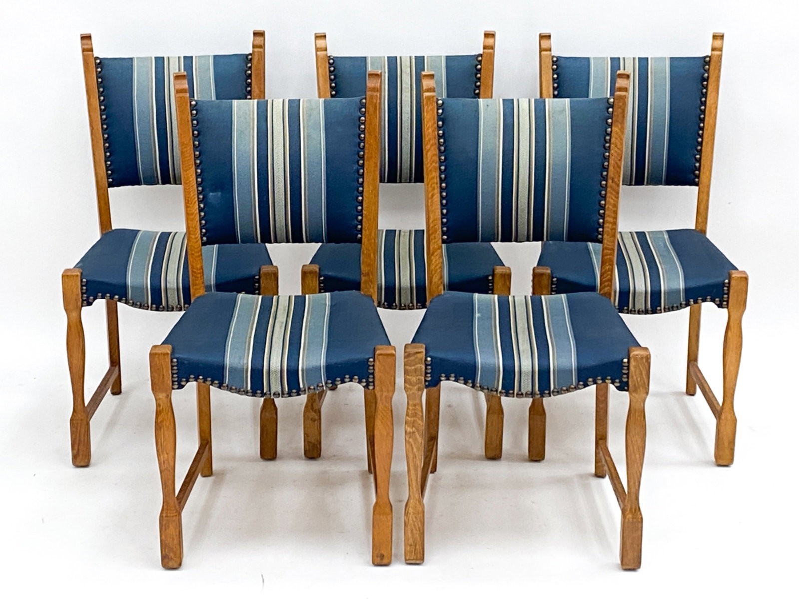 (5) DANISH OAK CHAIRS IN THE MANNER OF KJAERNULF: In the manner of Henning Kjaernulf Dimensions: H 35" x W 18" x D 16" Seat height 17" Condition: Wear consistent with age and use. Minor tears to corners of upholstery. Scattered scratches to wood.