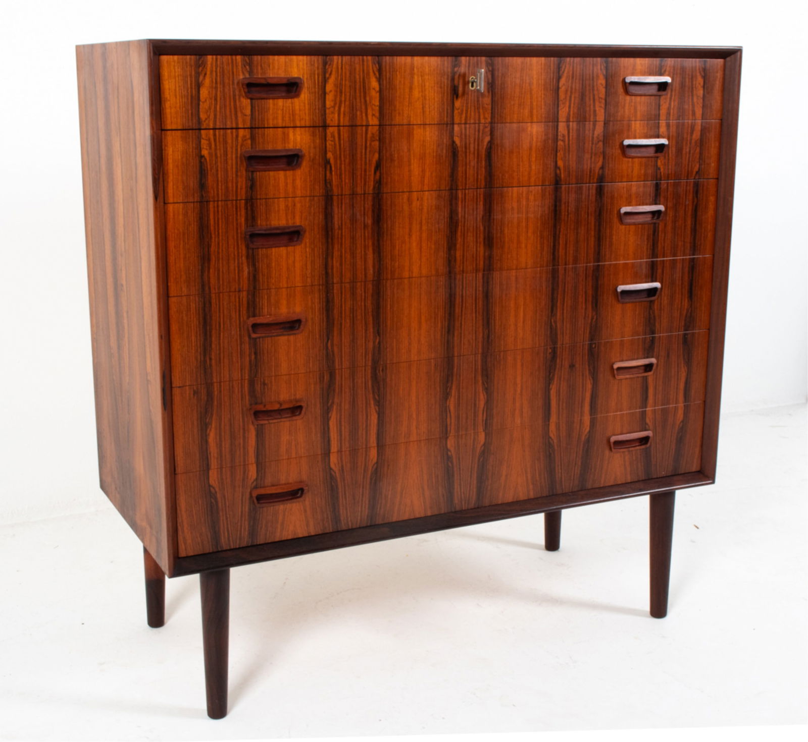 JOHANNES SORTH FOR NEXO DANISH ROSEWOOD CHEST: Key included. Molded inset drawer pulls. Tapered legs. Circa 1960's. Dimensions: H 40" x W 39.5" x D 18". Condition: Wear consistent with age and use. B001