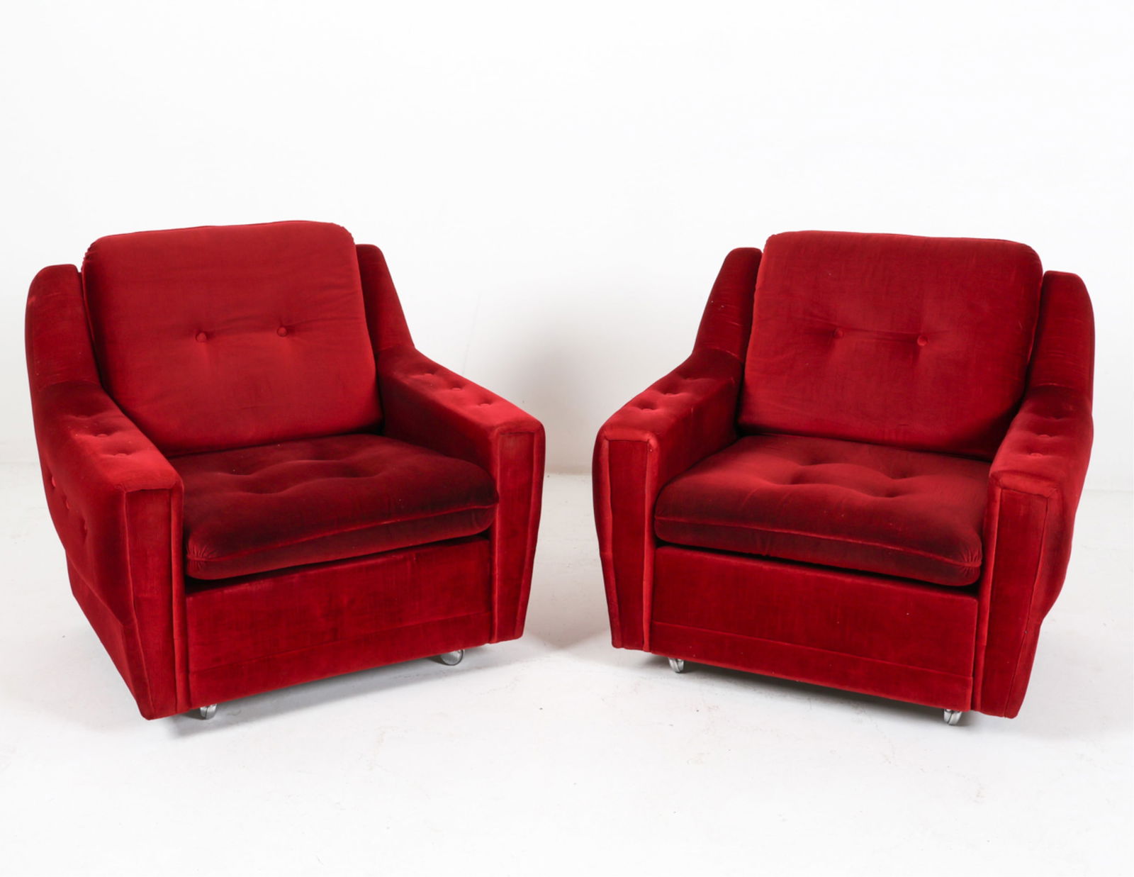 PAIR OF DANISH TUFTED LOUNGE CHAIRS, C.1960'S: Denmark. Tufted backs and arms. Set on casters. Dimensions: H 31.5" x W 31" x D 30" x SH 14.25". Condition: Small tear in backing fabric to one. Few signs of wear to fabric. Wear consistent with age a