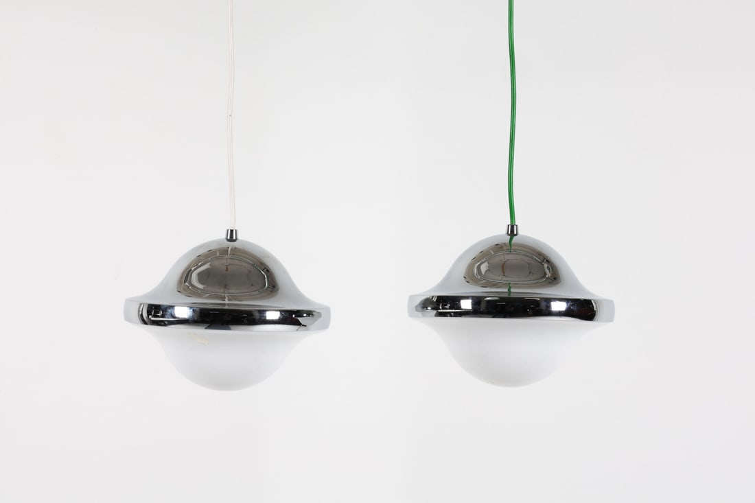 (2) HENNING KOPPEL 'BUBI' PENDANT LIGHTS, C.1960'S: For Carl Hansen & Son. Chromed steel with plastic shades. Denmark, circa 1960's. Dimensions: H 6.75" x Dia. 9". Condition: Wiring untested, cords cut. Few faint scuffs to chrome finish. Wear consisten