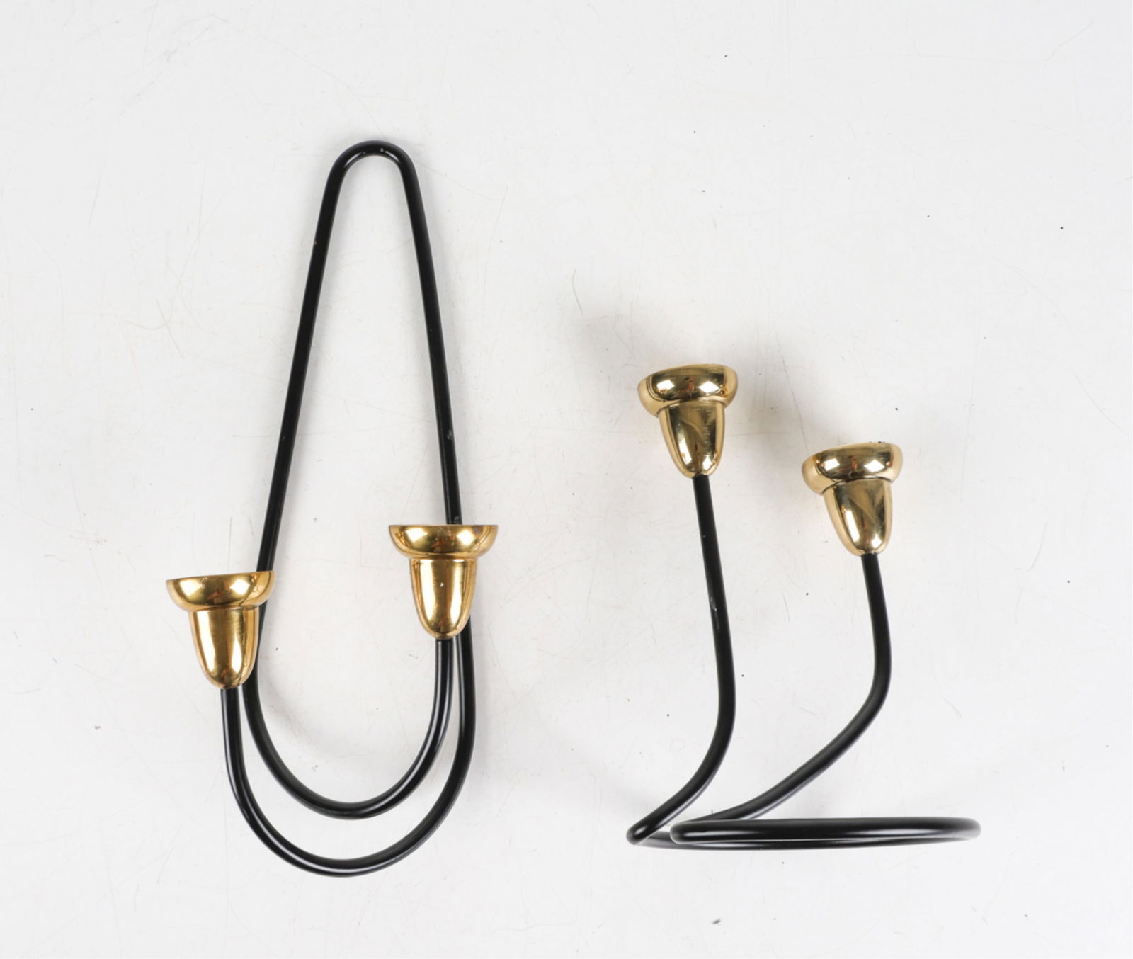 PAIR SCANDINAVIAN BRASS & IRON CANDLEHOLDERS: One sconce, and one candlestick. Scandinavian, circa 1980's. Dimensions: Tallest H 15.5" x W 5.75". Condition: Minor scuffs to brass finish. Wear consistent with age and use.