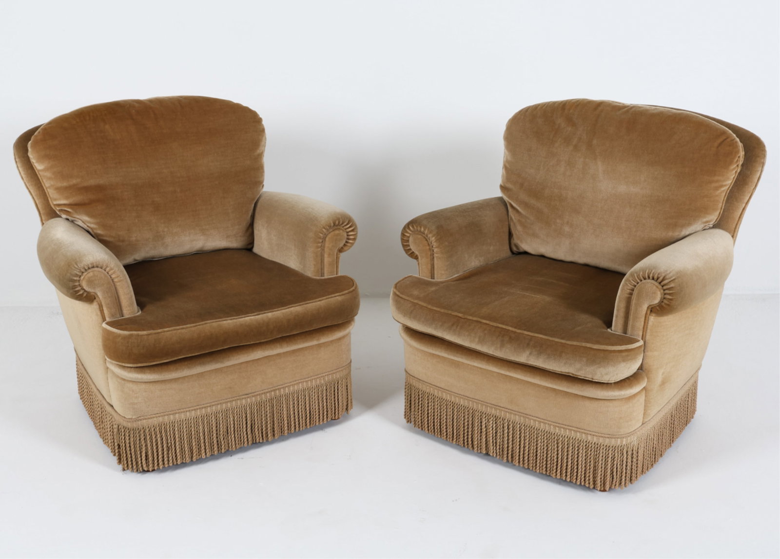 (2) MOHAIR VELVET LOUNGE CHAIRS C.1960'S: With fringe edges. Dimensions: H 34" x W 32.5" x D 37" Seat height: 16.5" Condition: Presents well overall. Minor indenting to back upholstery.