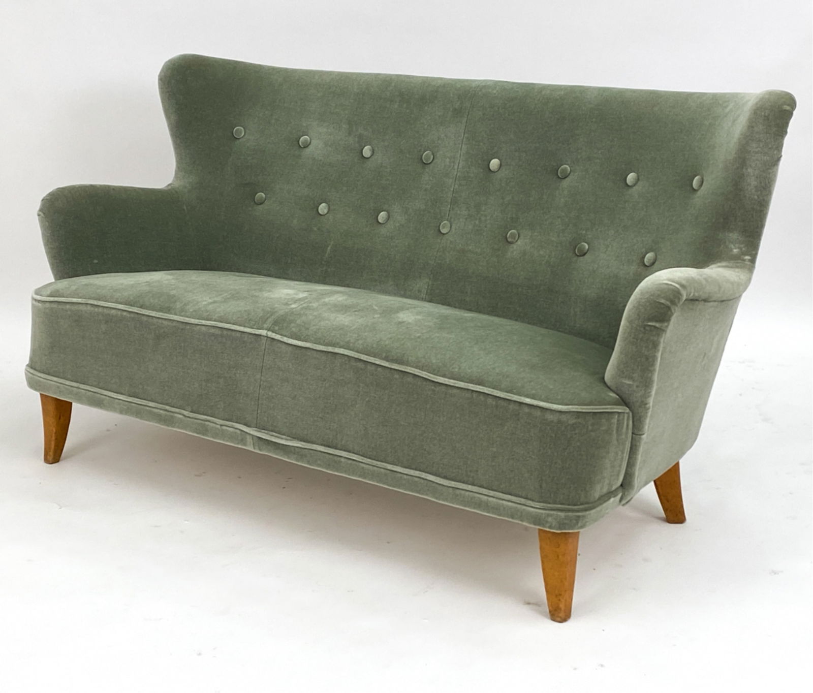 MANNER OF ILMARI LAPPALAINEN MOHAIR SOFA 1950S: Tufted back with pine feet. Light green tone Mohair upholstery. Dimensions: H 30.5" x W60.5" x D 27" Seat height: 16" Condition: Slight wear to mohair to proper left arm. Minor scuffs to mohair to bac