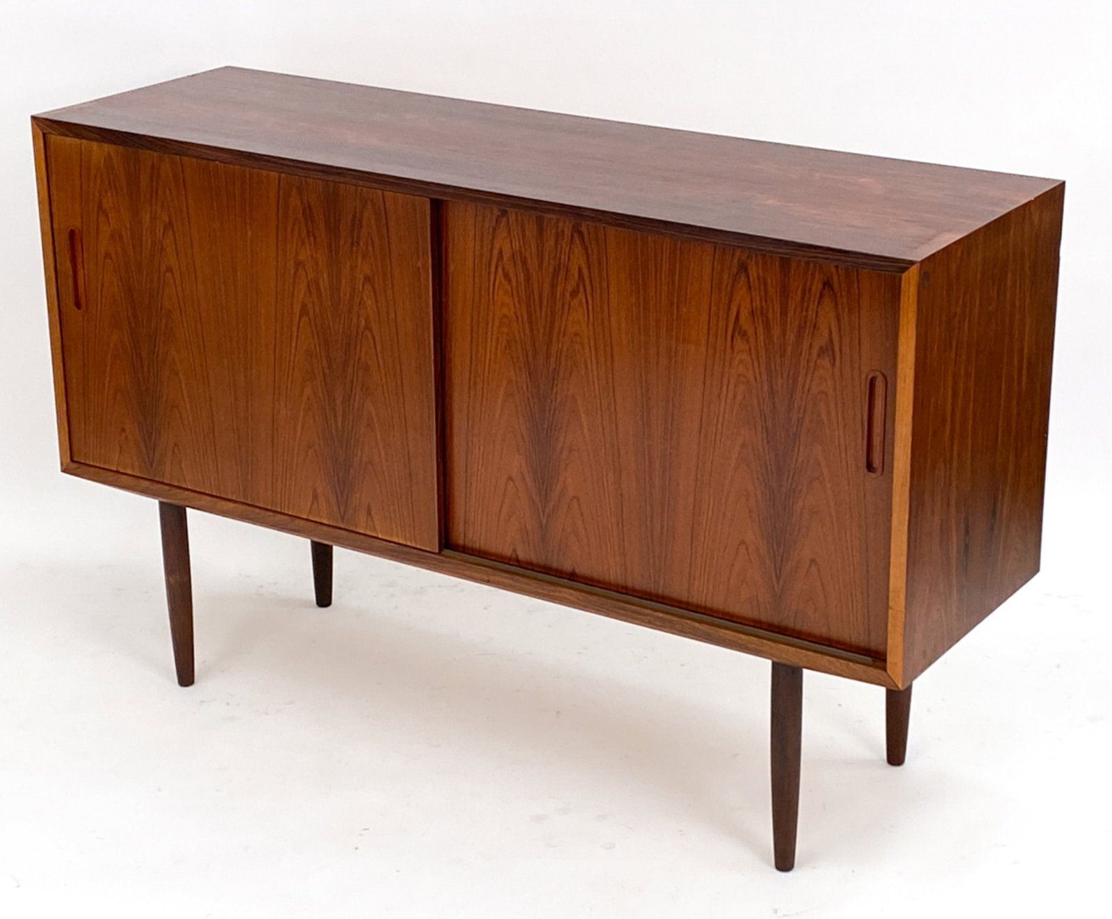 HUNDEVAD DANISH ROSEWOOD SIDEBOARD C.1960'S: Stamped to backside and Danish label to interior. With adjustable shelves. Dimensions: H 34"x W 54"x D 17" Condition: Hole to backside. Scattered marks, scuffs and dings to top PJ132