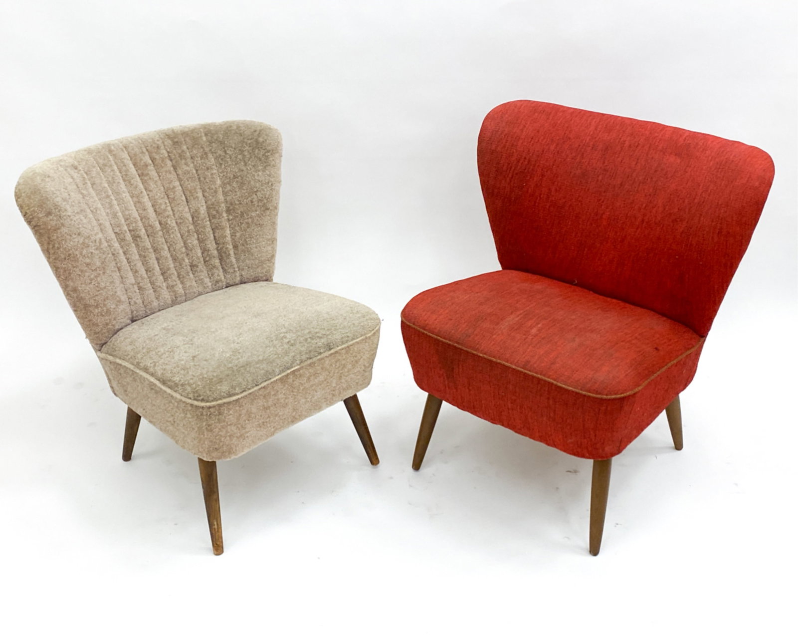 DUTCH COCKTAIL CHAIRS C.1960'S: Red fabric with cord accent, other one with channel back in off white tone shag fabric. Dimensions: (largest) H 27"x W 25.5" x D 27" Seat height: 17" Condition: Blemishes and sun fading to both. Scuff