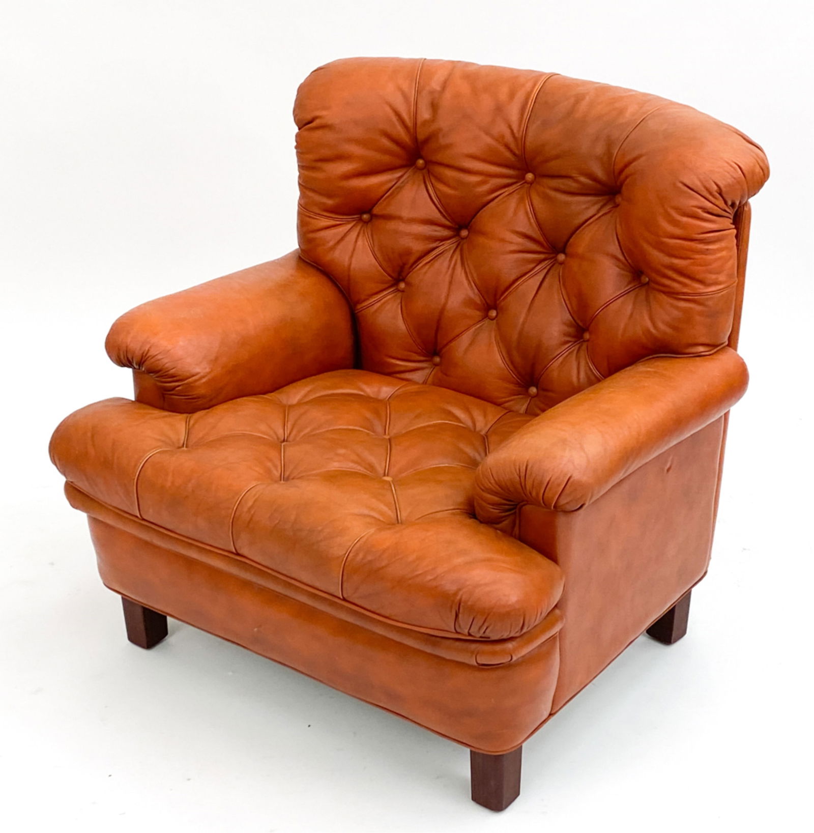 ARNE NORELL "MEXICO" LEATHER LOUNGE CHAIR: Arne Norell leather armchair, model "Mexico". Norell label underneath seat cushion. Circa 1960's. Dimensions: H 33" x W 33.5" x D 33" Condition: Light distress to leather and slight sun fading consist
