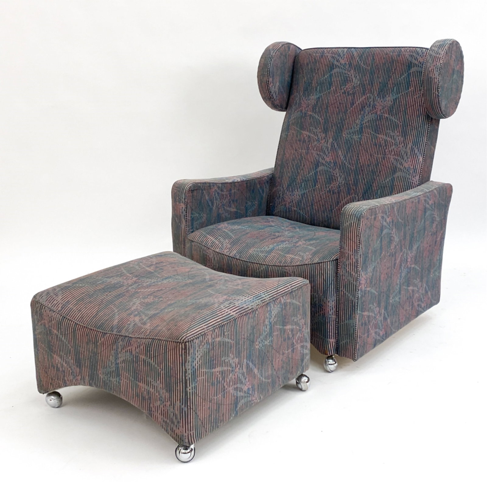 20TH C. GERMAN EAR BACK LOUNGE CHAIR & OTTOMAN: Lounge chair and ottoman to match in vintage fabric, on casters. Circa 1970's. Unsigned. Dimensions: H 39" x W 29.5" x D 30" x SH 13" Condition: Couple rubs to fabric edge of ottoman, wear consistent 