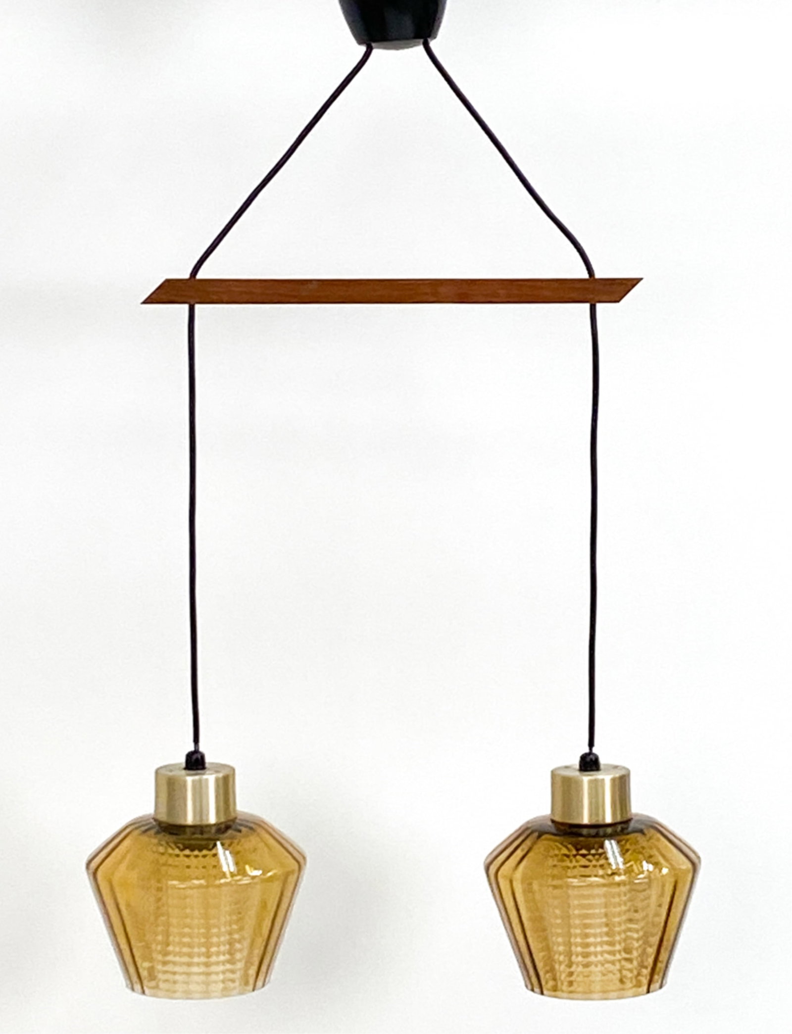 ATTR. FAGERLUND AMBER GLASS PENDANT LAMP C.1950'S: Teak, amber glass with inner texture clear glass center. Dimensions: H 31.5" x W 14.5" (glass) Dia 6.75" Condition: Slight marks and nicks to metal caps, Nicks to glass edges. Untested. PJ199