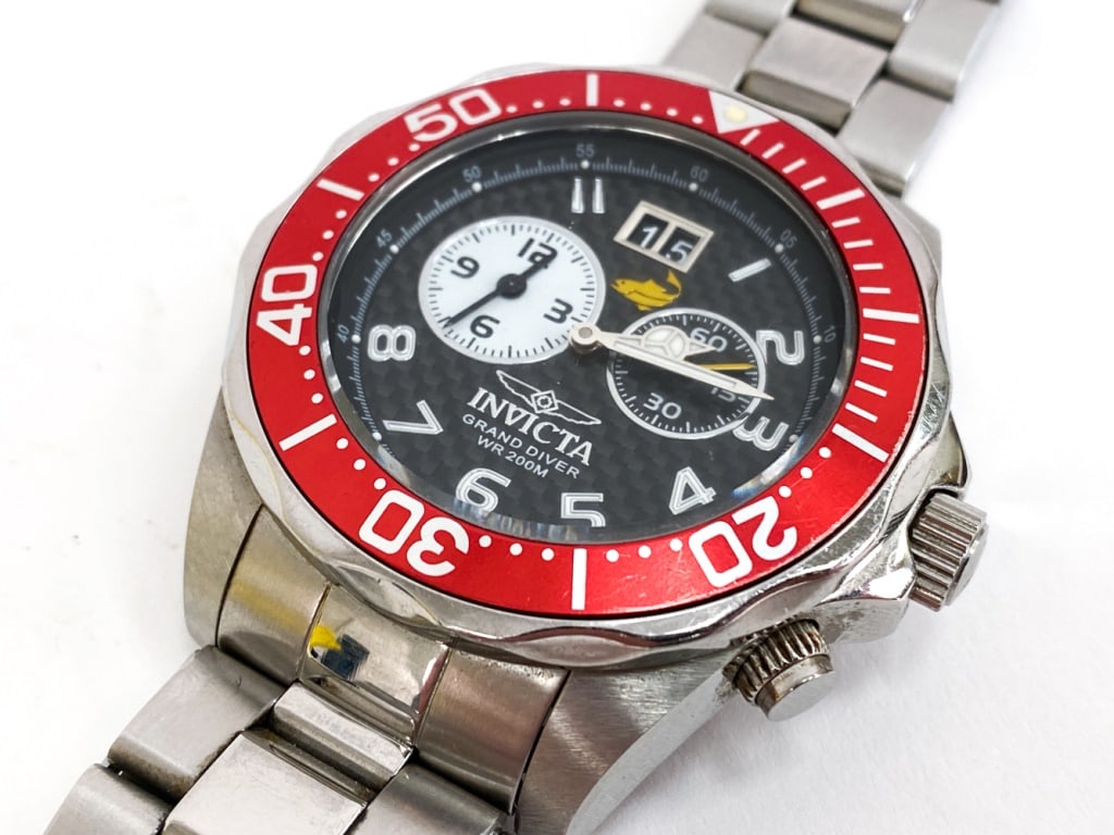 INVICTA GRAND DIVER CHRONOGRAPH MENS WATCH: Featuring a 47mm stainless steel case with a carbon fiber face and a quartz movement. Model number 14444. Marked on face and on backside. Swiss movement. Includes instructions manual and Invicta case
