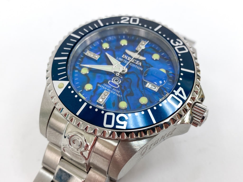 INVICTA GRAND DIVER LTD. ED. MENS WATCH: Featuring a 50mm stainless steel case with 9 small white diamonds on face. Model number 23983. Marked on face and on backside. Includes instructions manual Invicta case for watch, and extra metal link