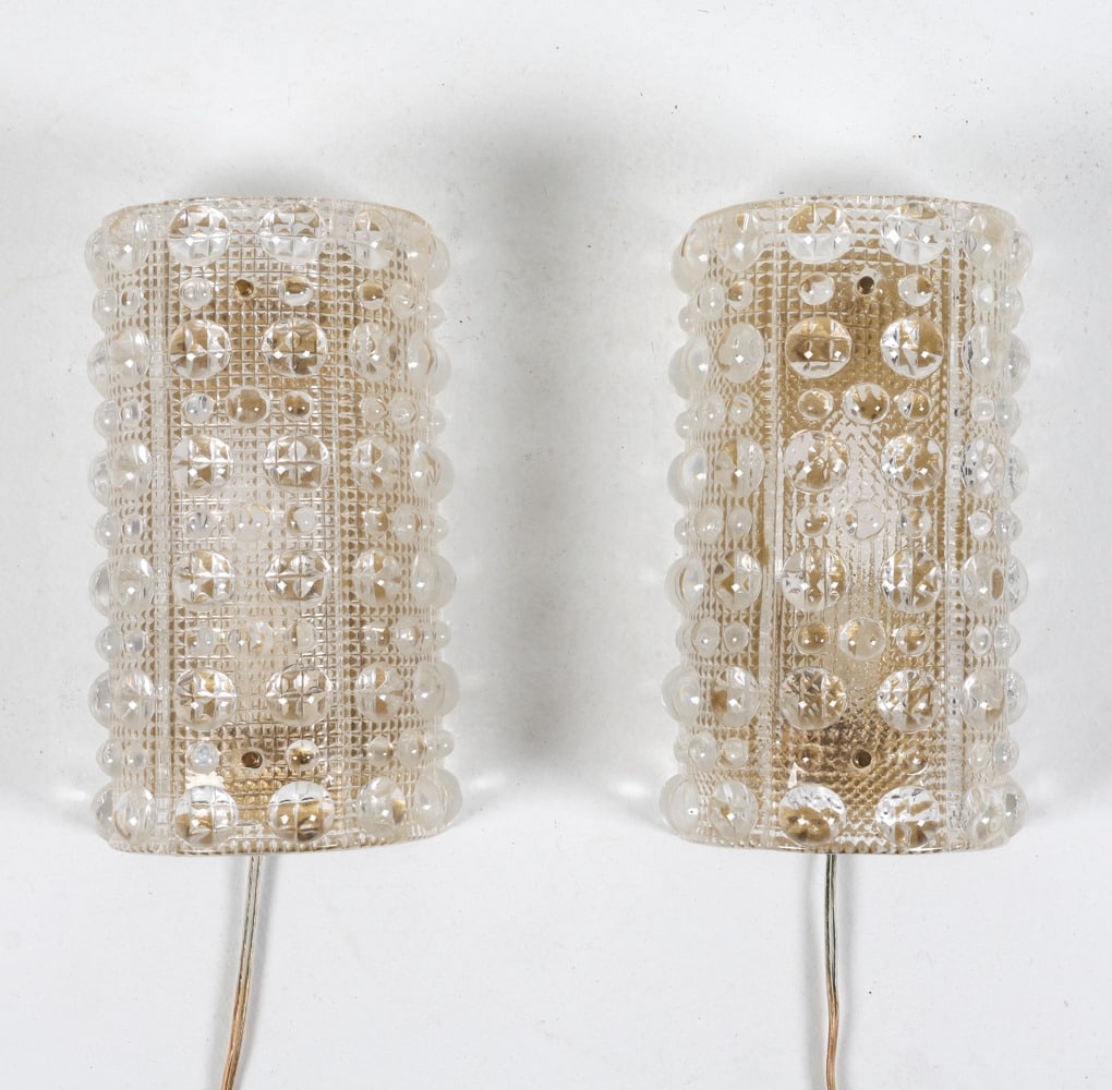 PAIR CARL FAGERLUND FOR ORREFORS SCONCES: For Lyfa and Orrefors. Brass plates. Circa 1960's. Dimensions: H 10" x W 6" x D 4.5". Condition: Missing hardware that attaches glass to brass plates. Few scuffs and rubs to brass. Some surface soilin