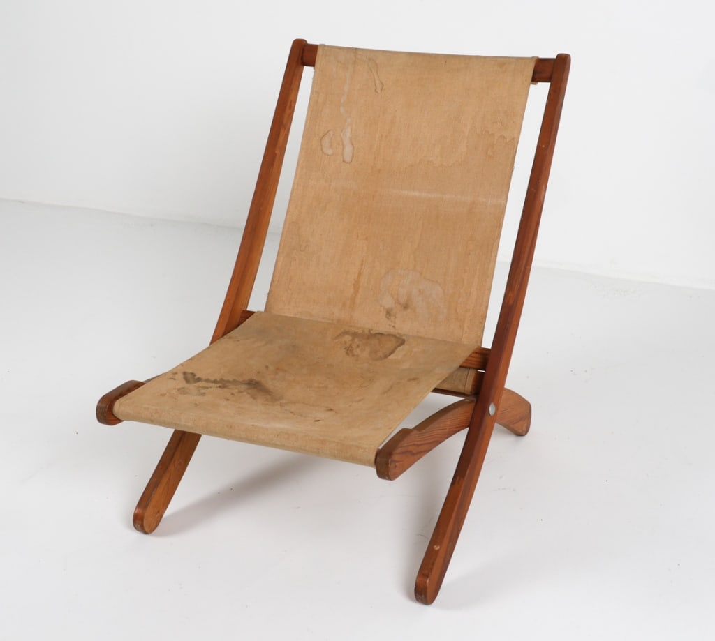 SCANDINAVIAN PINE FOLDING CHAIR, CIRCA 1970'S: Fabric sling seat. Dimensions: H 29" x W 22" x D 30" x SH 12". Condition: Few areas of discoloration and surface soiling to fabric. Few scuffs and faint water marks on wood. Wear consistent with age a