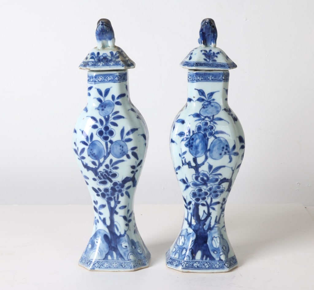 19TH C. CHINESE PORCELAIN VASES W/ LIONS: Blue and white decoration with lions on lids. Dimensions: H 13.5" x Dia. 3.75". Condition: Few rubs and chips to glazing on top around rim. Scuffs underneath on base. Wear consistent with age and use.