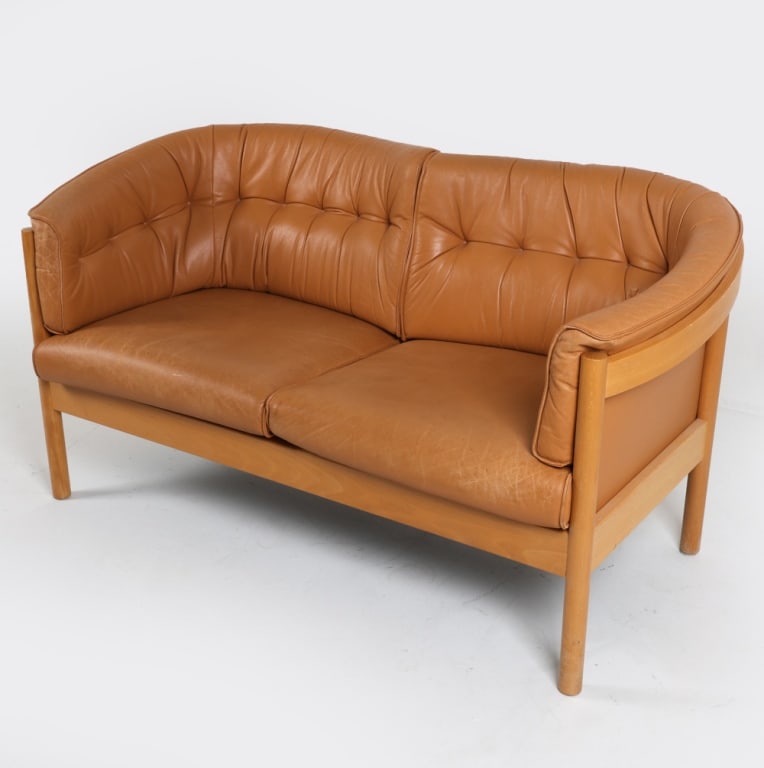 NIELAUS & JEKI DANISH BEECH & LEATHER SOFA: Marked under cushions. Beech frame with caramel tone cushions. Dimensions: H 30" x W 58.5" x D 31" x Seat height 17". Condition: Creases and sun fading to leather. Rubbing and scuffs on frame. Wear co