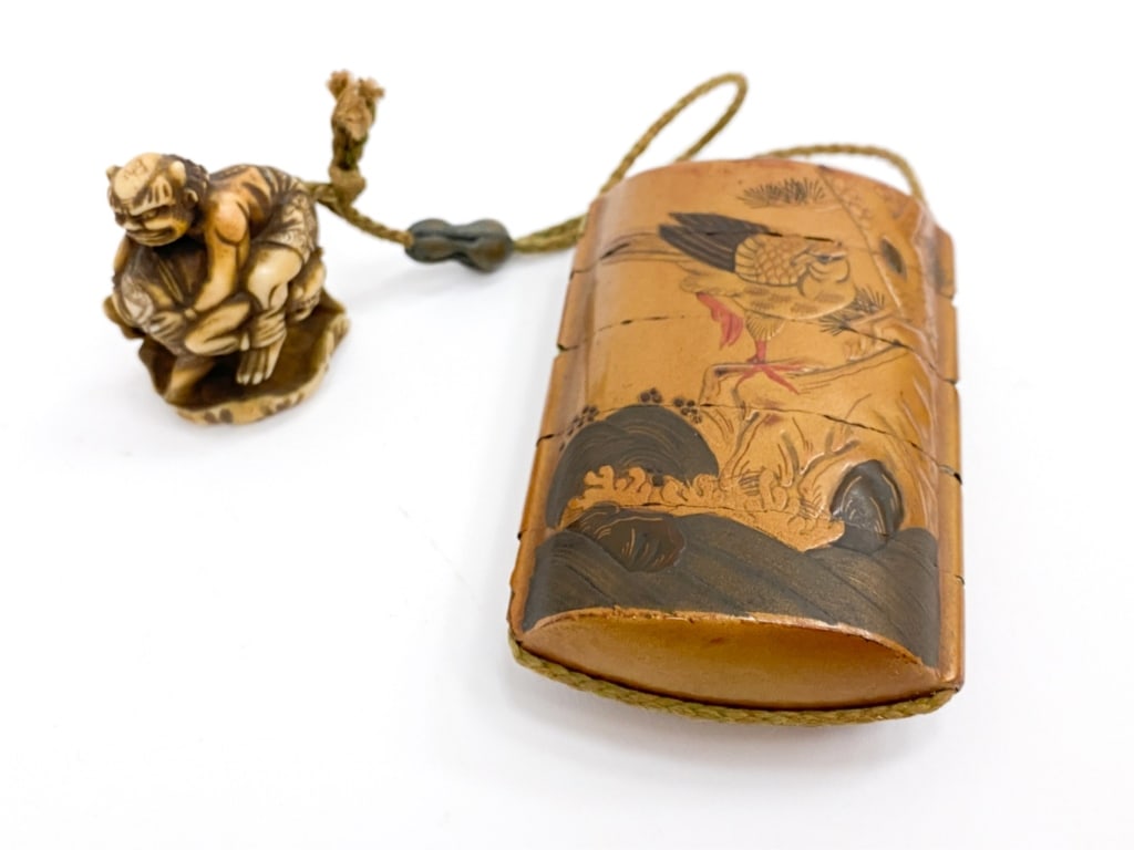 JAPANESE INRO CONTAINER AND NETSUKE: Japanese lacquered wooden tiered container (inro) with signed carved bone netsuke of two wrestling demons (oni) Dimensions: (Container) H 3.5" x W 2.25"x D 1" (Nestuke) H 2" x W1.25" Condition: wear t