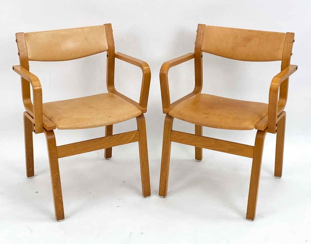 PAIR BENTWOOD OAK & LEATHER ARMCHAIRS, CIRCA 1970: Pair of leather and oak armchairs in the style of Alvar Aalto. Unsigned. Circa 1970's. Dimensions: H 31.75" x W 22.25" x D 20" x SH 19" Condition: Water stains and marks to leather cushions. Surface w