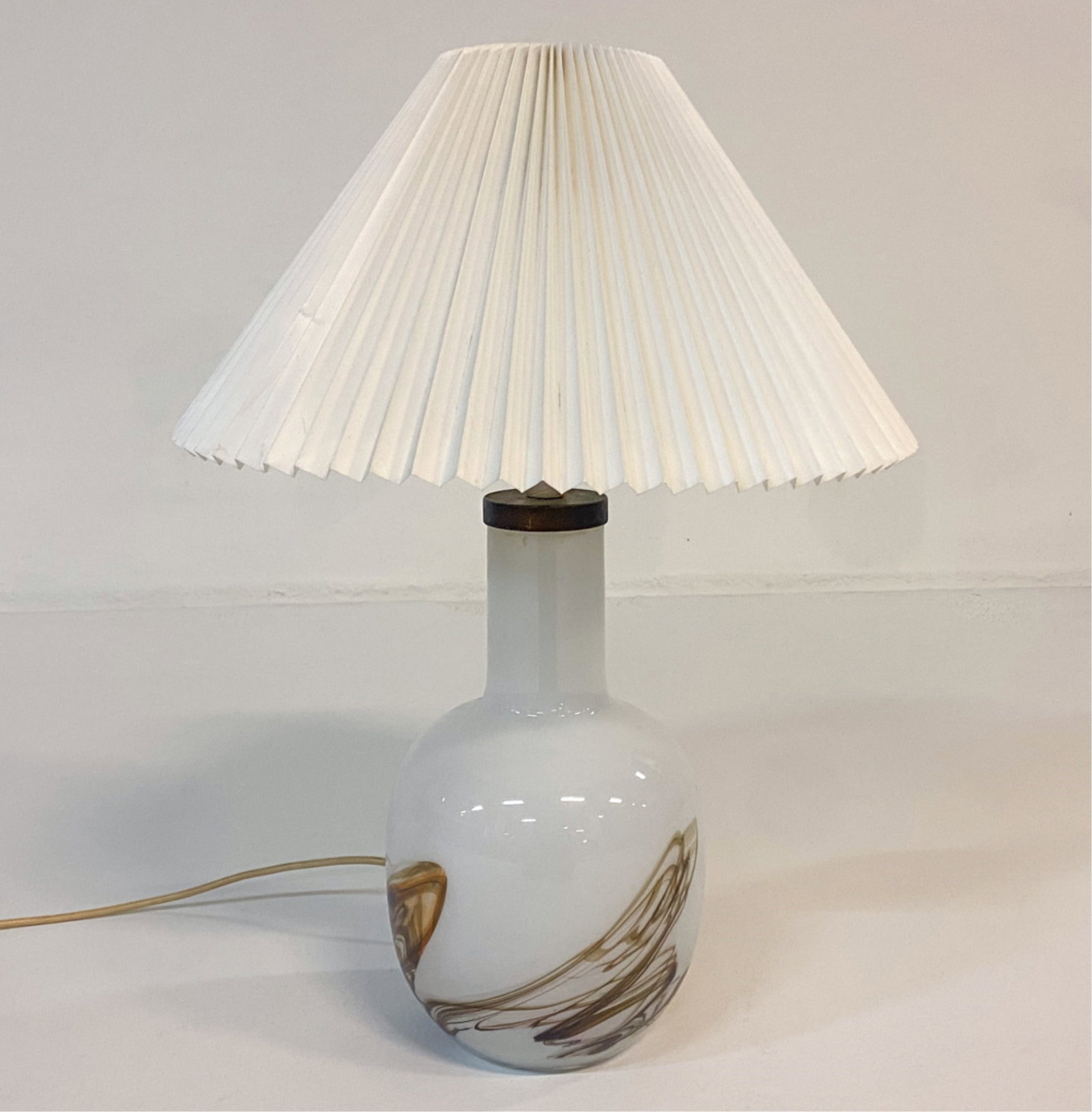 HOLMEGAARD DANISH CASCADE TABLE LAMP C. 1960'S: Hand blown glass base. Pleated shade. Dimensions: H 16" x Dia 6" Shade: Dia 16" Condition: surface soiling to glass. Crack to socket. Blemishes and creases to shade. Cut wire. Untested. A017